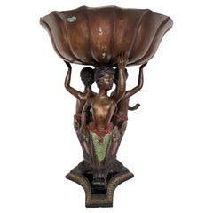Bronze riser with 20th century putti sculpture