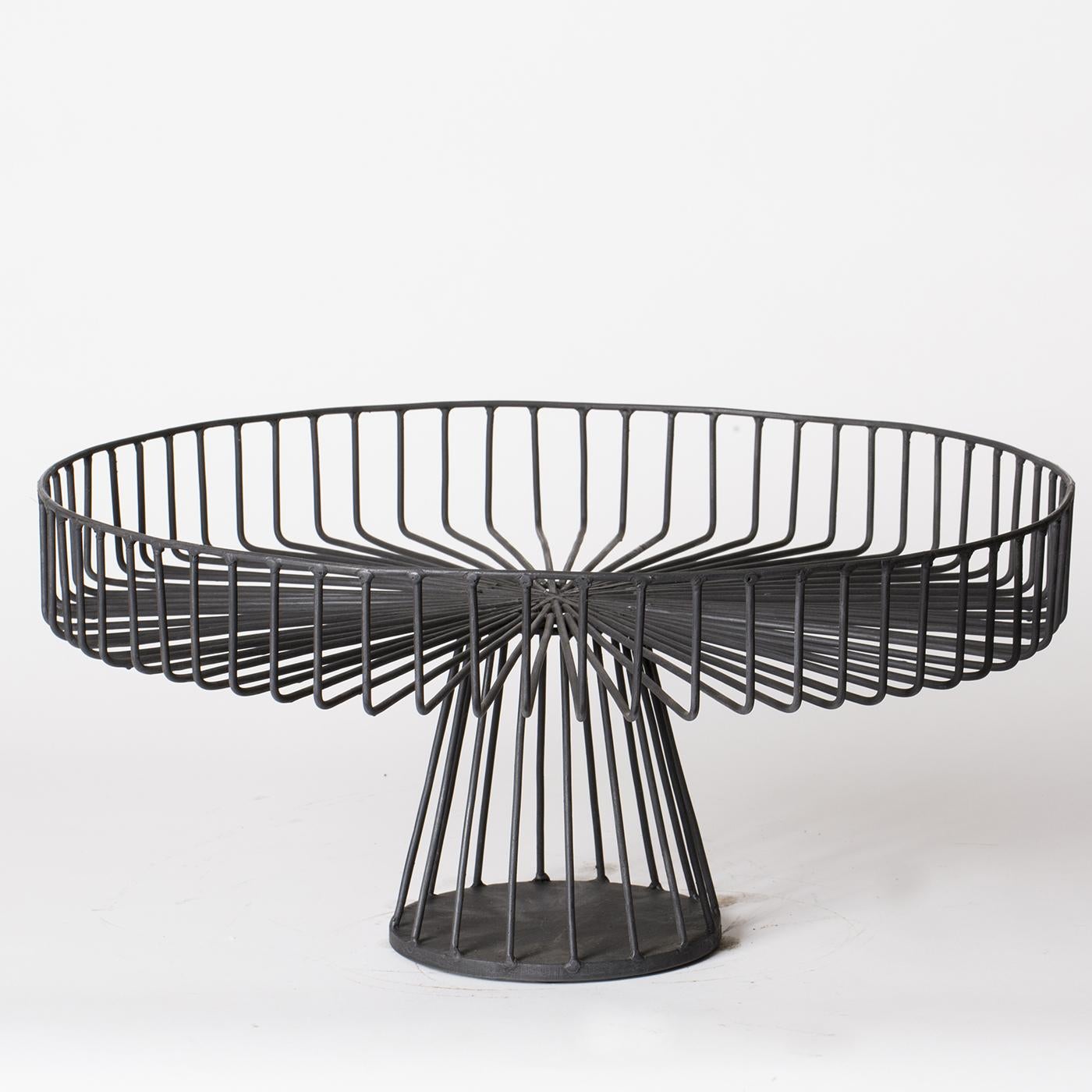 This sculptural centerpiece by Sciortino is formed of tempered iron wire with a matte black finish. The rigid straightness of the lines contrasts delightfully with the rounded dimensions of the base. Product dimensions may vary slightly. 



 