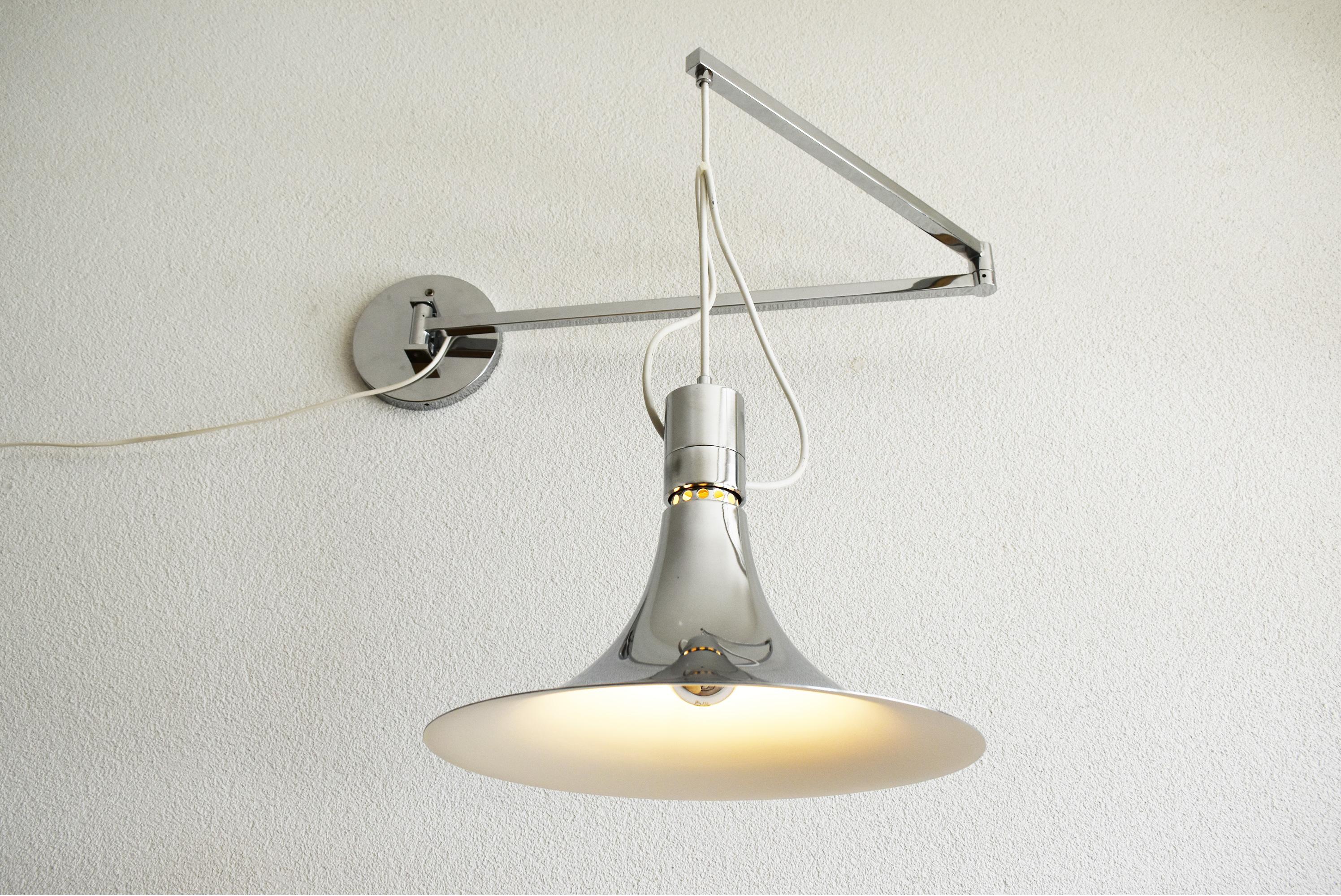 The AM/AS wall lamp with chromed swing arm was designed in Italy by Franca Helg and Franco Albini for Sirrah in 1969. It is in very good condition, complete and ready for immediate use.
What sets this lamp apart is its ingenious swing arm mechanism,
