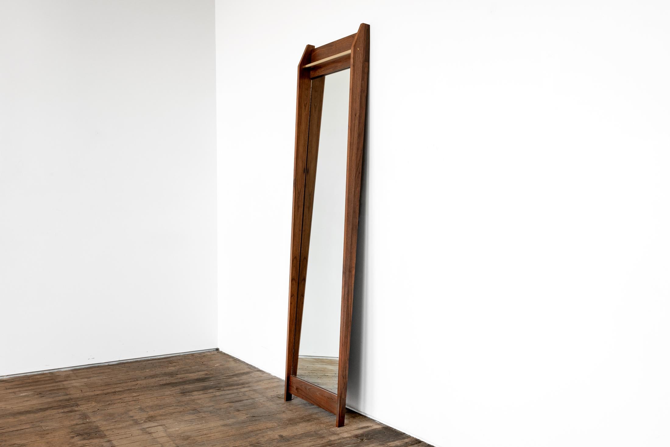 Am1 is a handmade, elegant full length mirror that leans effortlessly against the wall, with the added detail of an upper bronze bar, to hang whatever you please.

Shown in solid walnut with bronze accent

Dimensions: 24”W x 84”H

All of our
