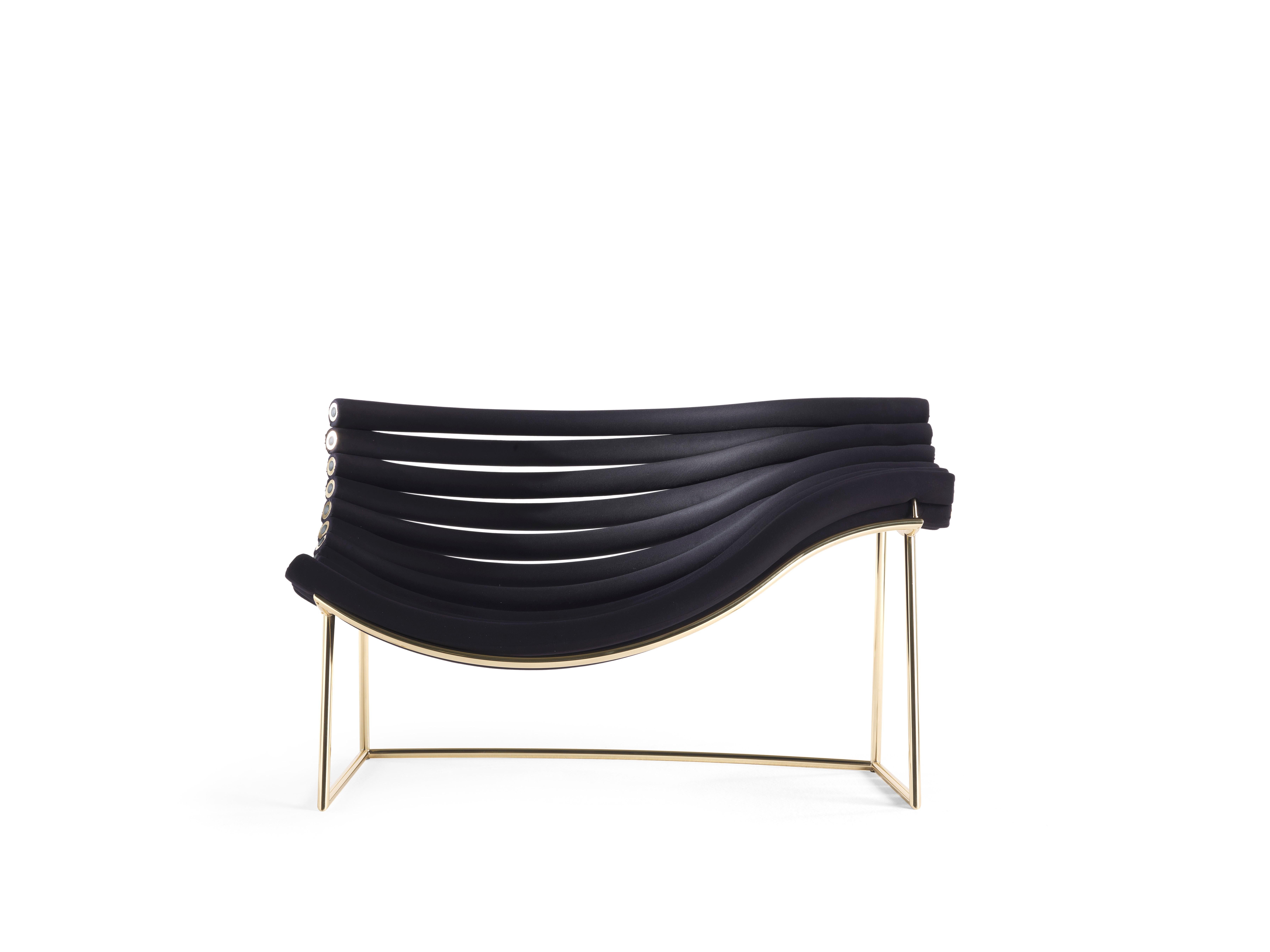 Amadea armchair by Debonademeo
Materials: Metal structure with polished gold finish, metal tubes covered in foam, upholstery in black elastic fabric.
Dimensions: 100 x 147 x 80 cm

Amedea is the materialization of the invisible, floating paths