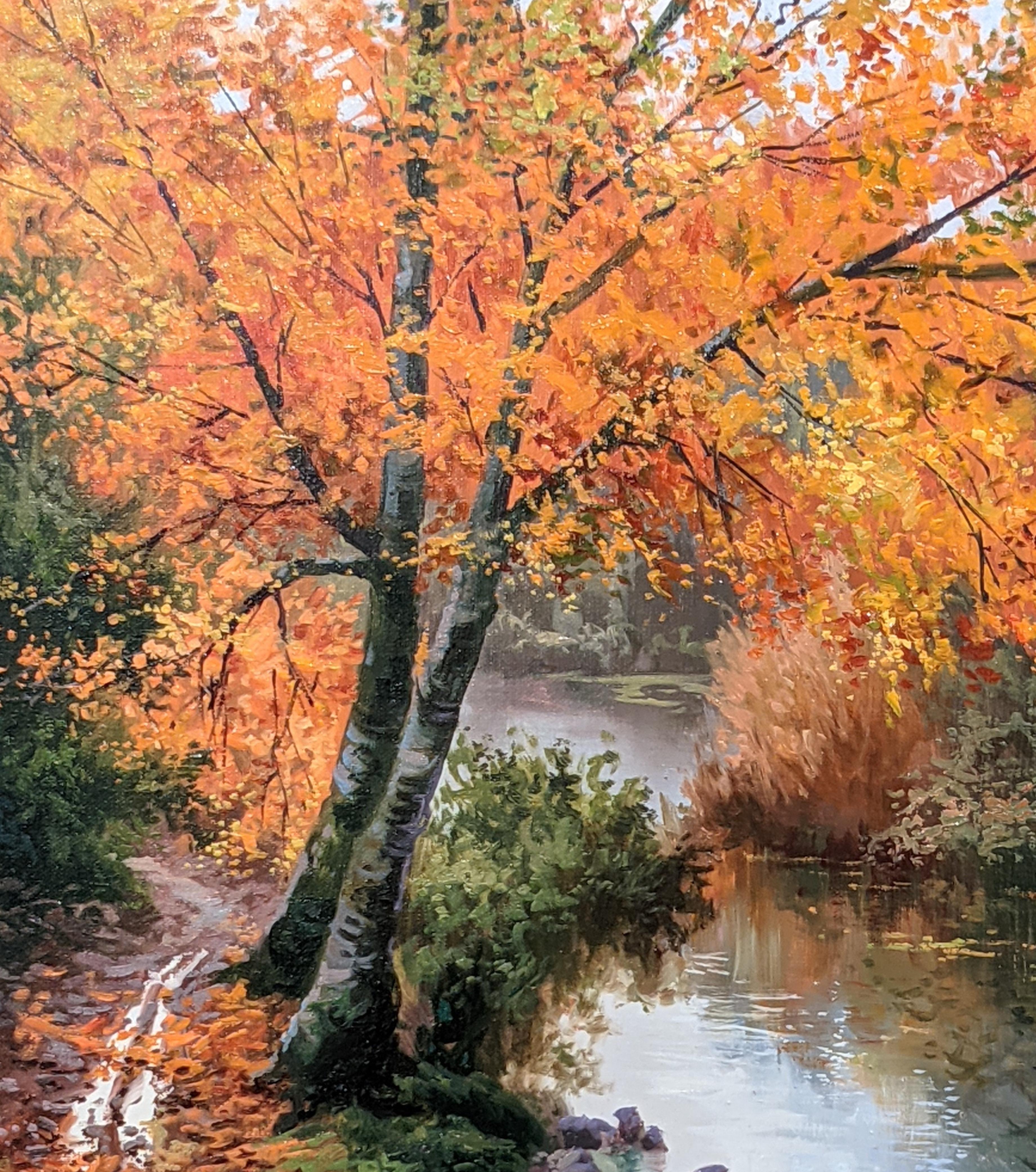 'Riverside Stroll' by Amal Amatt. A Red & Orange  Contemporary landscape painting of a river and incredibly detailed trees. 

Amatt was born in the hot arid climate of Southern Spain but fell in love with lush landscape of woodland and mountains of