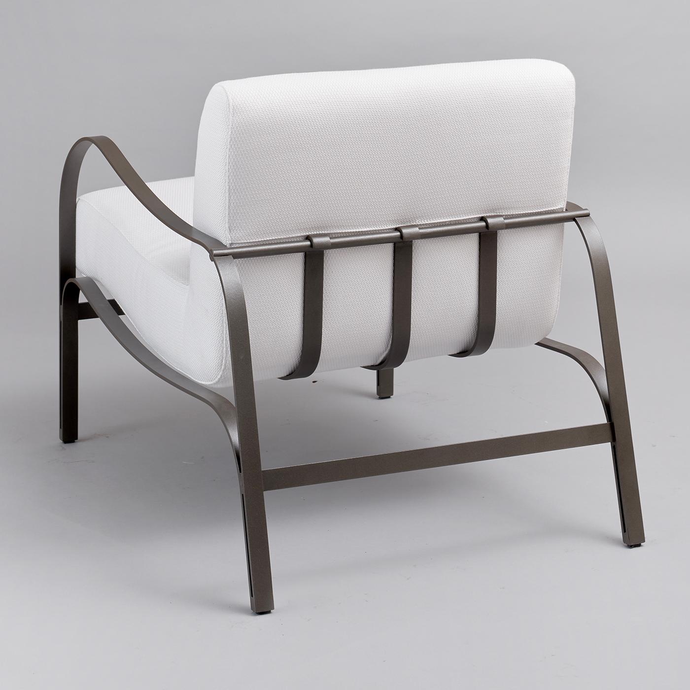 Fluid curves trace the welcoming profile of this refined outdoor armchair, designed by Studio 63 for the elegant Amalfi Collection. Ideally combined with its chaise longue counterpart, it features a generously stuffed cushioned seat covered in