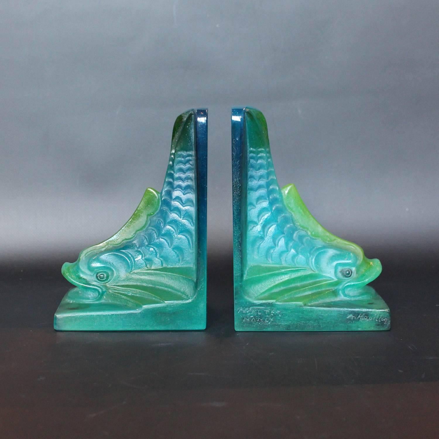 A pair of Art Deco pâte de verre bookends in the form of stylised dolphins. Designed by Auguste Houillon (1885-1954) for Amalric Walter, Nancy, France. Etched Walter Nancy and A Houillon to sides.

 