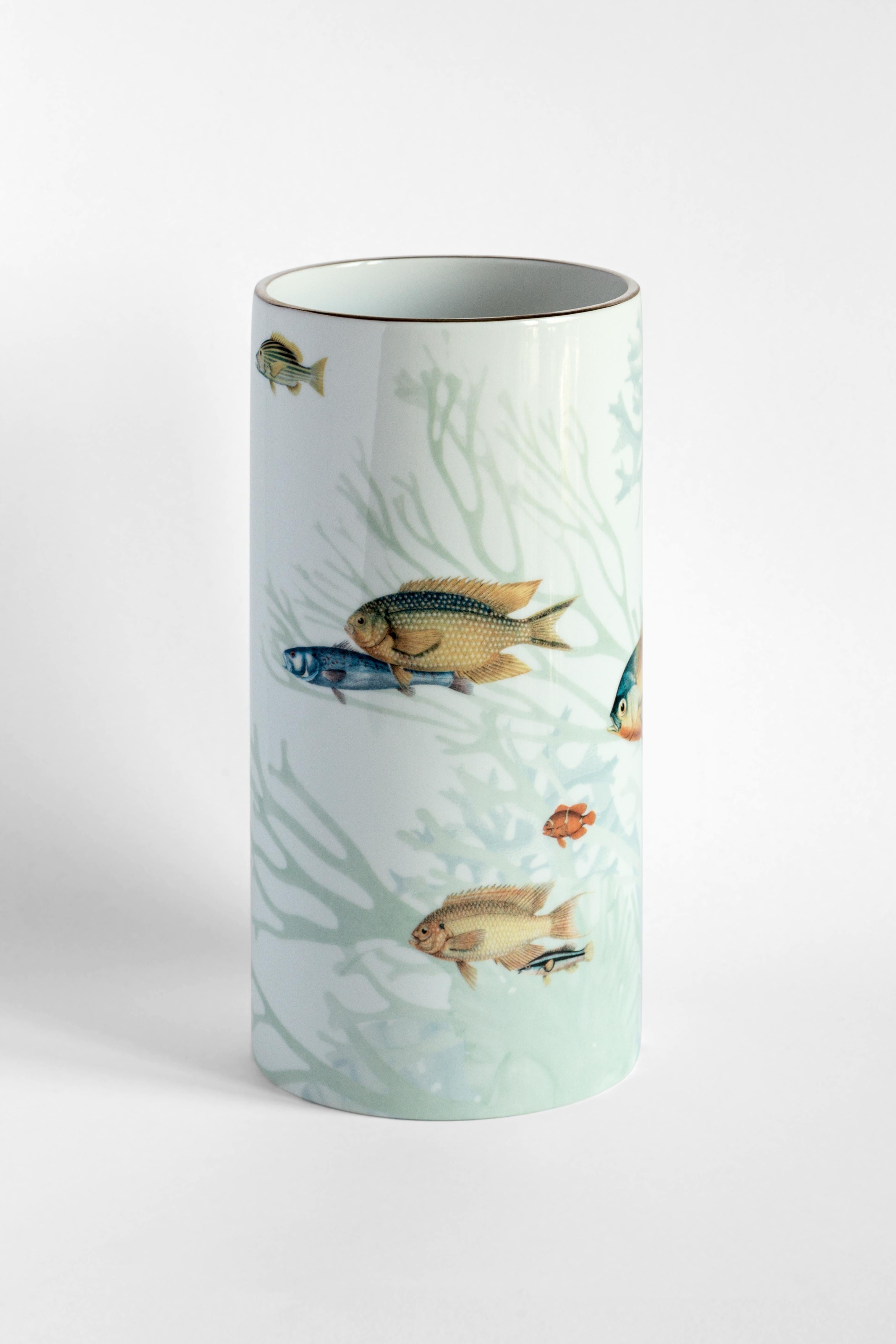 Inspired by the Japanese Amami Islands ringed by coral reefs, this joyful vase designed by Vito Nesta features a playful pattern of different-sized fish in dazzling colors. Crafted of Fine porcelain, this vase will make a delightful addition to a