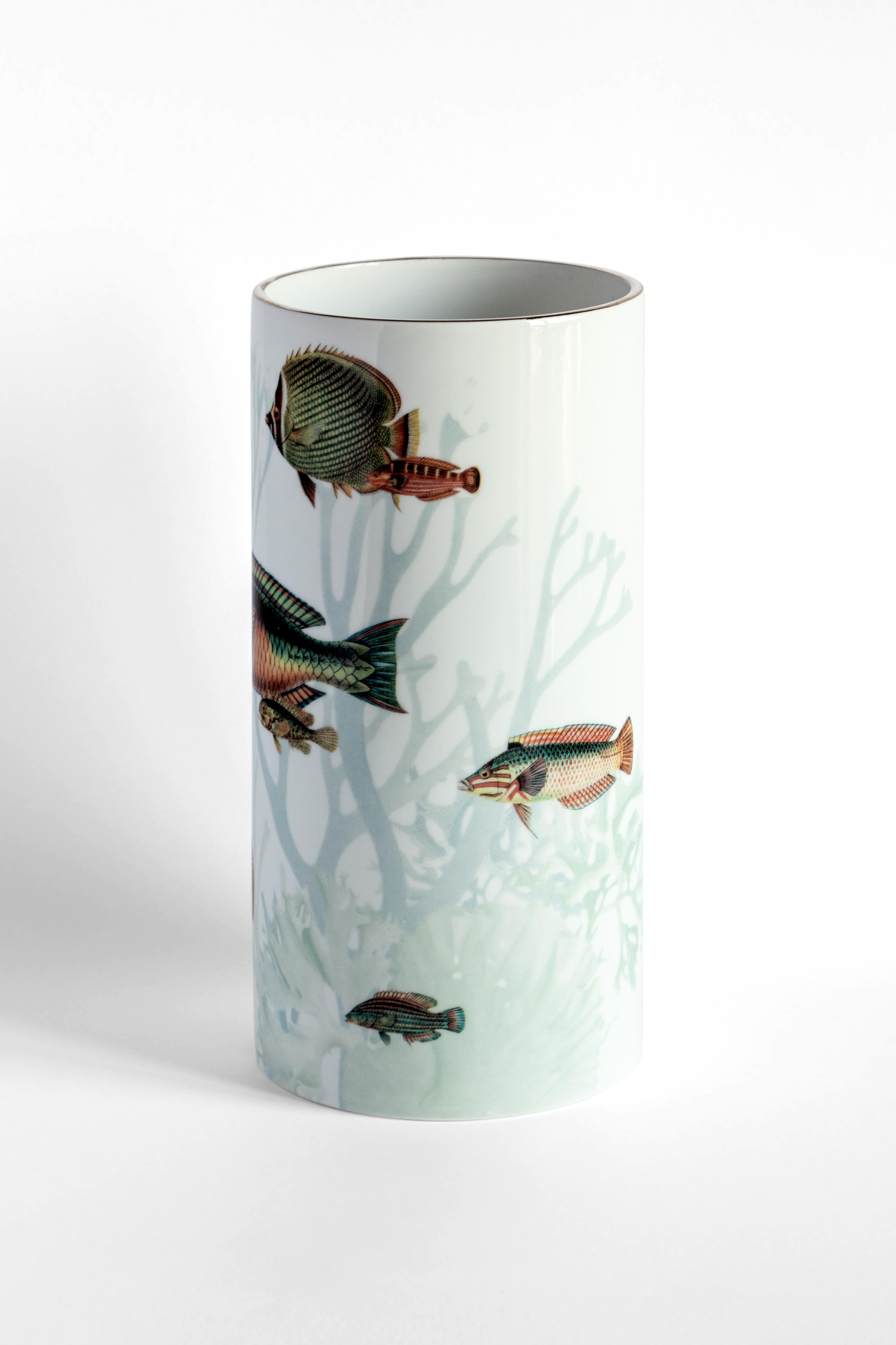 Inspired by the Japanese Amami Islands ringed by coral reefs, this joyful vase designed by Vito Nesta features a playful pattern of different-sized fish in dazzling colors. Crafted of fine porcelain, this vase will make a delightful addition to a