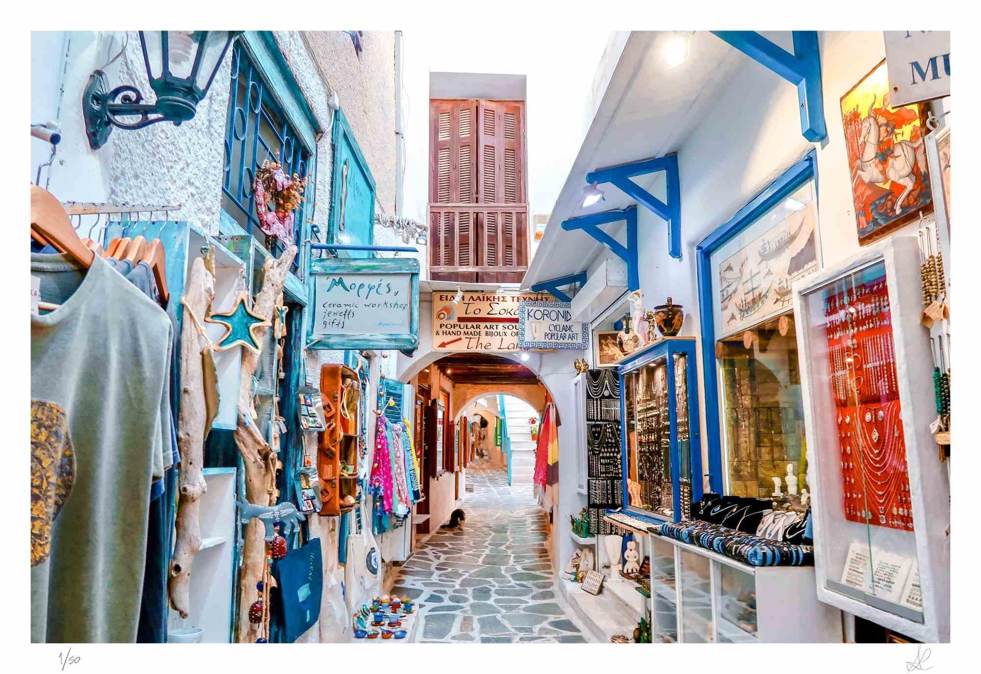 Greek Market is a photograph taken by Amanda Ludovisi in 2018.

It represents a colorful narrow street inside the Greek market in Naxos, emblematic of the Greek culture. This is a giclée print on Canson Baryta Matt paper. Limited edition of 50