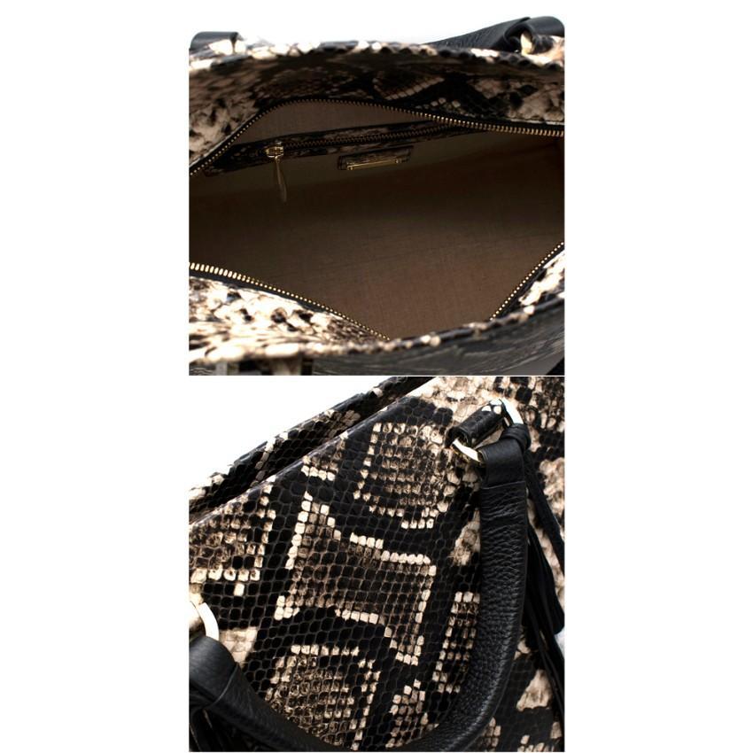 Amanda Wakeley Black Python Embossed Shopper Bag

-Embossed exotic python print
-Sturdy leather material
-Beautifully crafted braided handles
-Tassel detailing 
-Gold-toned Amanda Wakeley hardware
-Internal pocket details: 2 x slip pockets, 1 x zip