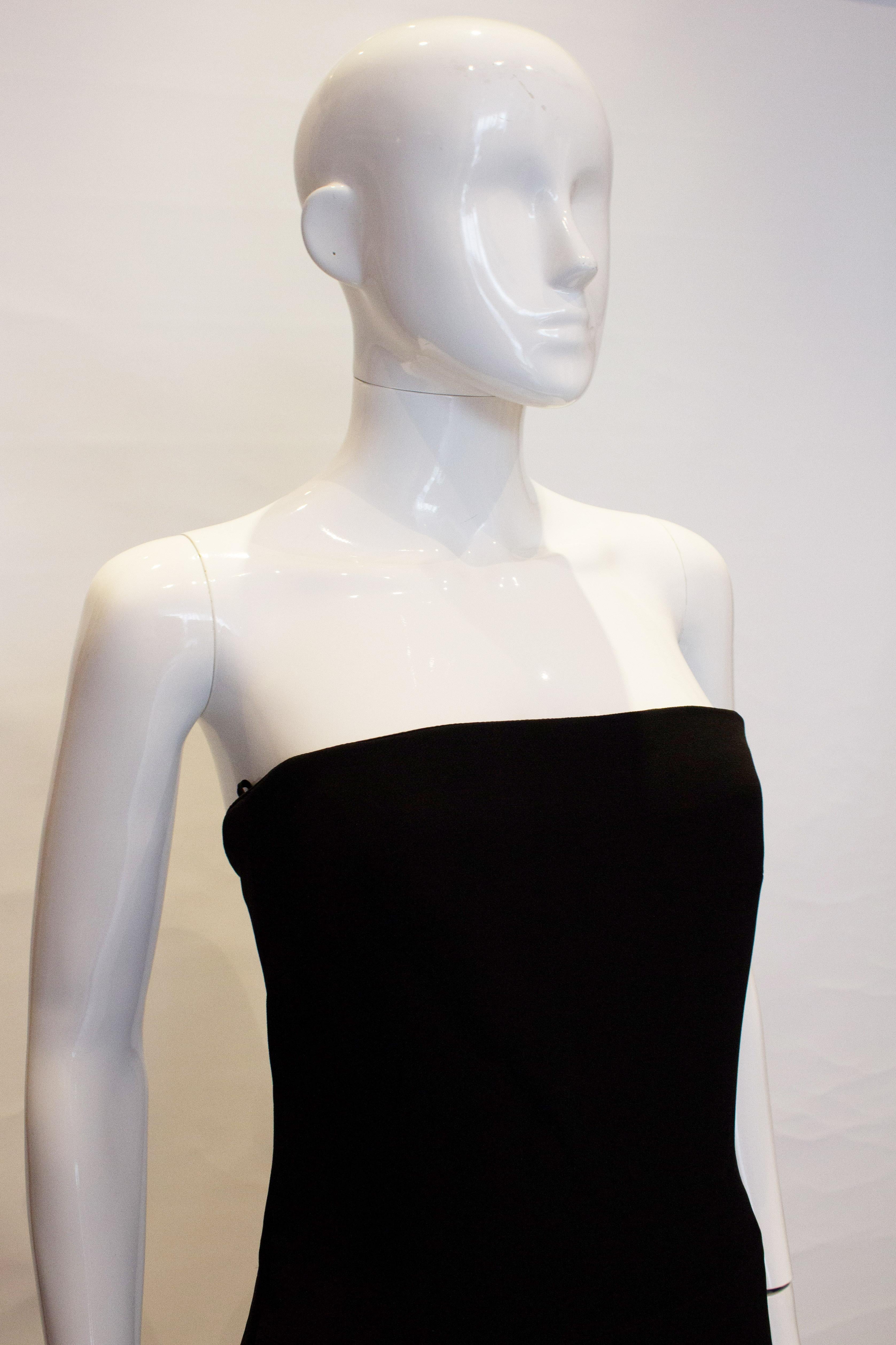 A chic cocktail  dress by Amanda Wakeley.The dress is strapless with beautiful tailoring and boning in the bodice area. It is fully lined with a central back zip.