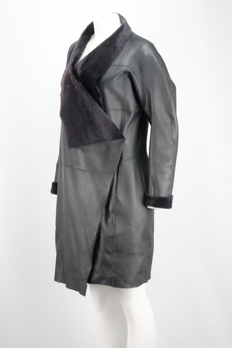 Amanda Wakeley Shearling Lined Leather Coat. Asymmetric hem and lapels in a wrap effect silhouette. Long sleeve, v-neck. Large ;apels. Navy. Snap button fastening at front. 100% Sheepskin; trim: 100% silk. Size: Large (UK 12, US 8, FR 40, IT 44).
