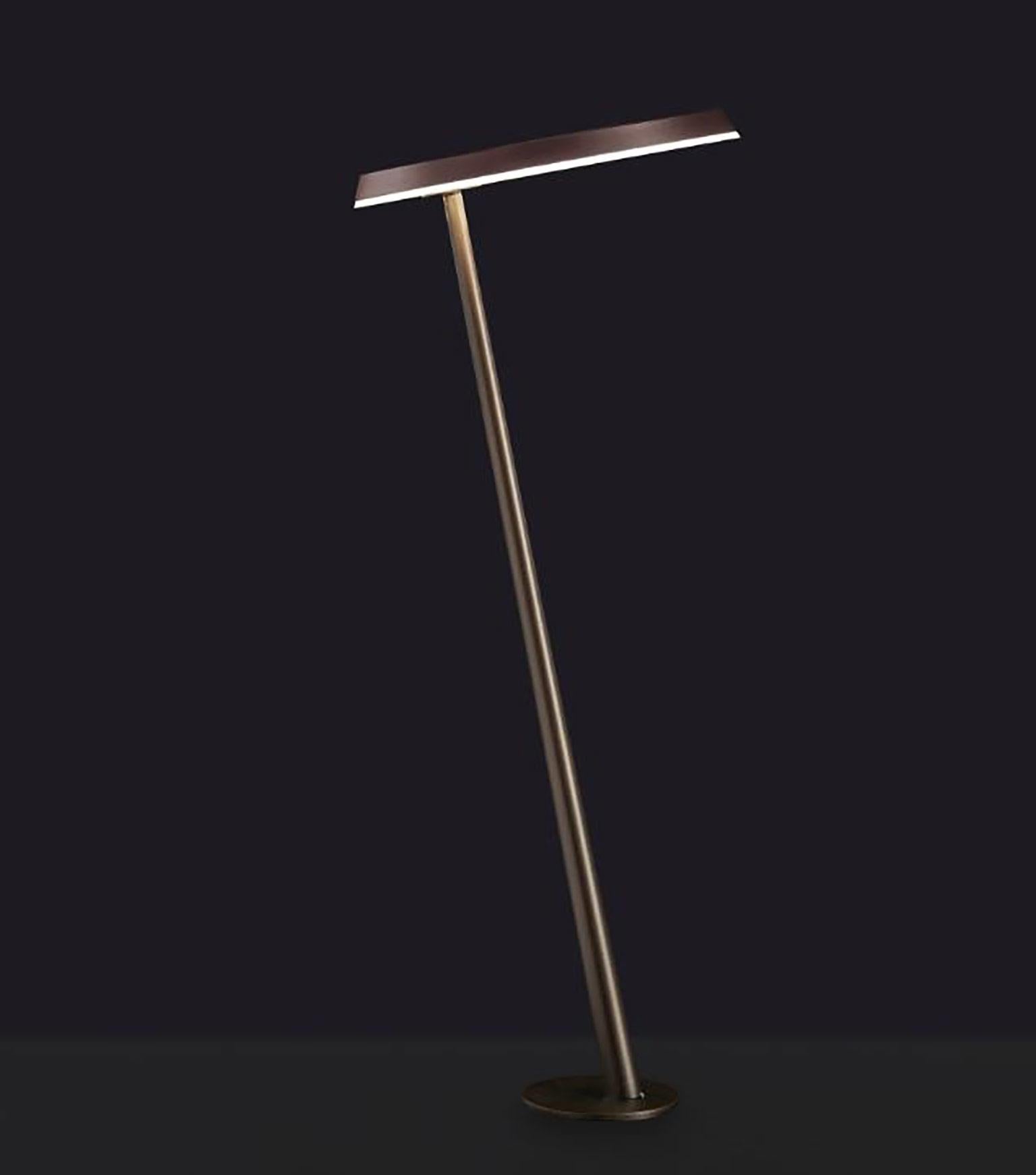 Amanita outdoor floor lamp by Mariana Pellegrino Soto for Oluce. The design of this fixture is two discs: one at the base which is slim and a second disk that is wider which houses the LED bulb. The two discs are connected by a slim slanted stem