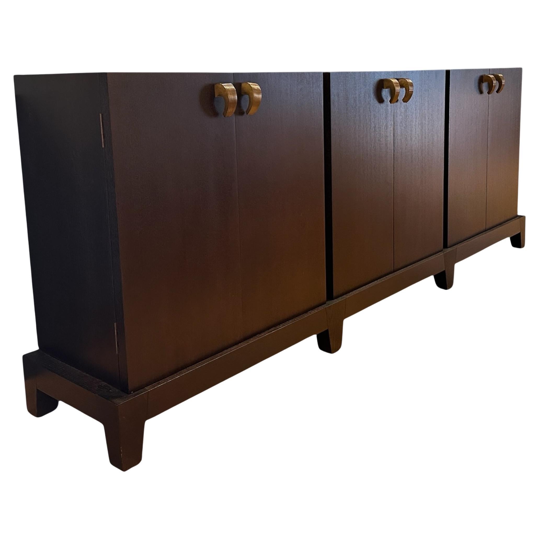 A historic design from Promemoria, the Amarcord Credenza was inspired by the 1975 Federico Fellini film of the same name.  Designer Romeo Sozzi drafted and created the modular cabinet in 1998 and has become the company's signature design.  A linear