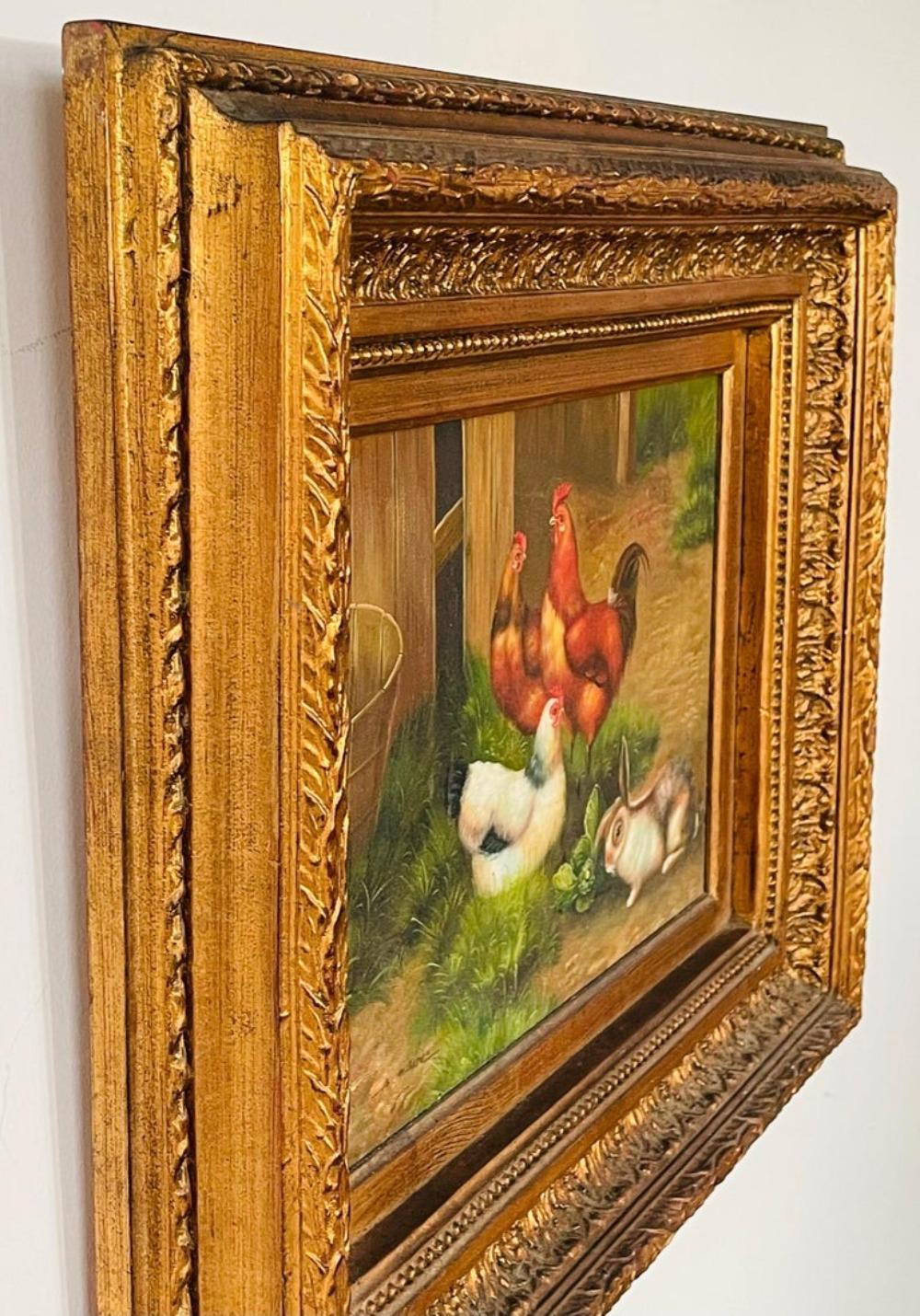 An antique oil on canvas painting showing roosters and a bunny in a farm rendered in the manner of Claude Guilleminet. The painting is presented in an exquisite carved gildwood frame and is signed in the bottom left by the artist 