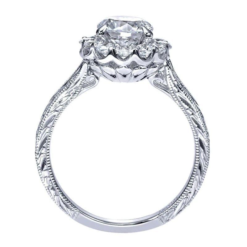 Beautiful and feminine, this stunning platinum engagement mounting features antique inspired details such as diamond etching and milgrain on the sides of the ring, and is crowned by an elegant round halo. Mounting contains 0.46 ctw of premium white