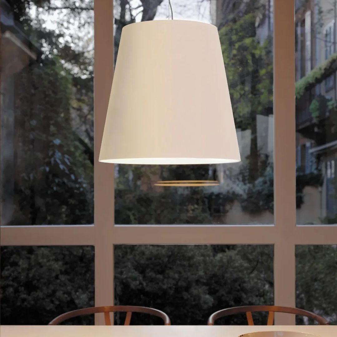 Designed by Charles Williams in 2003, this fixture takes a classic tapered design and reinterprets it on a large scale to offer drama and elegance to a space. A chromed metal frame is surrounded by a polyethylene diffuser to soften any glare from