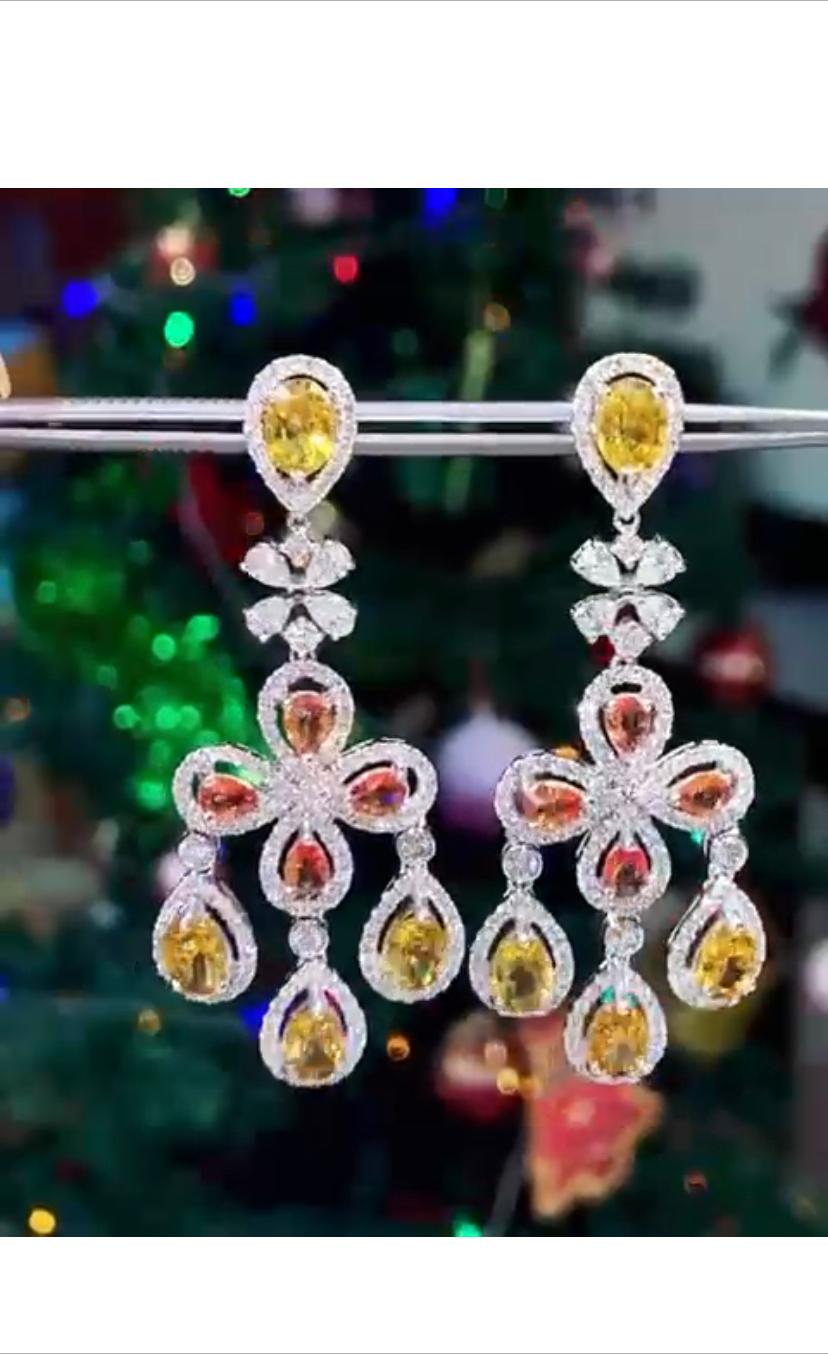 An exclusive and refined design , so original , fashion , a very explosion of color and beauty .
Earrings come in 18k gold with  Natural Orange/Yellowish Sapphires, in perfect  pear cut,  extra fine quality, of 13,90 carats and natural  diamonds