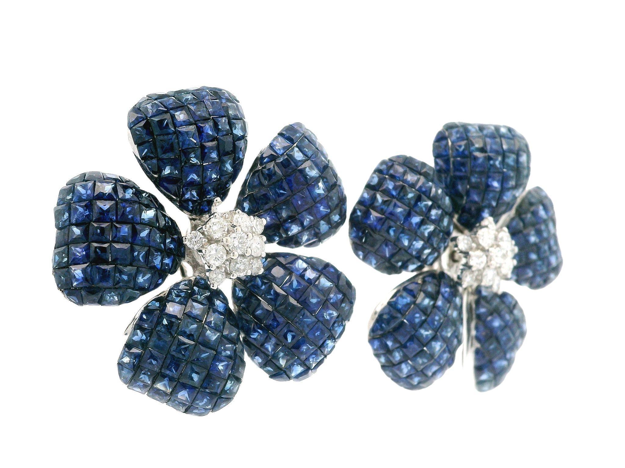 --Stone(s):--
Numerous Natural Genuine Sapphires - Square Step Cut & Calibre Cut - Invisible Mystery Set - Royal Blue Color 
(22) Natural Genuine Diamonds - Round Brilliant Cut - Prong Set - White Color - 0.75ctw (approx.)

Material: Solid 18k White
