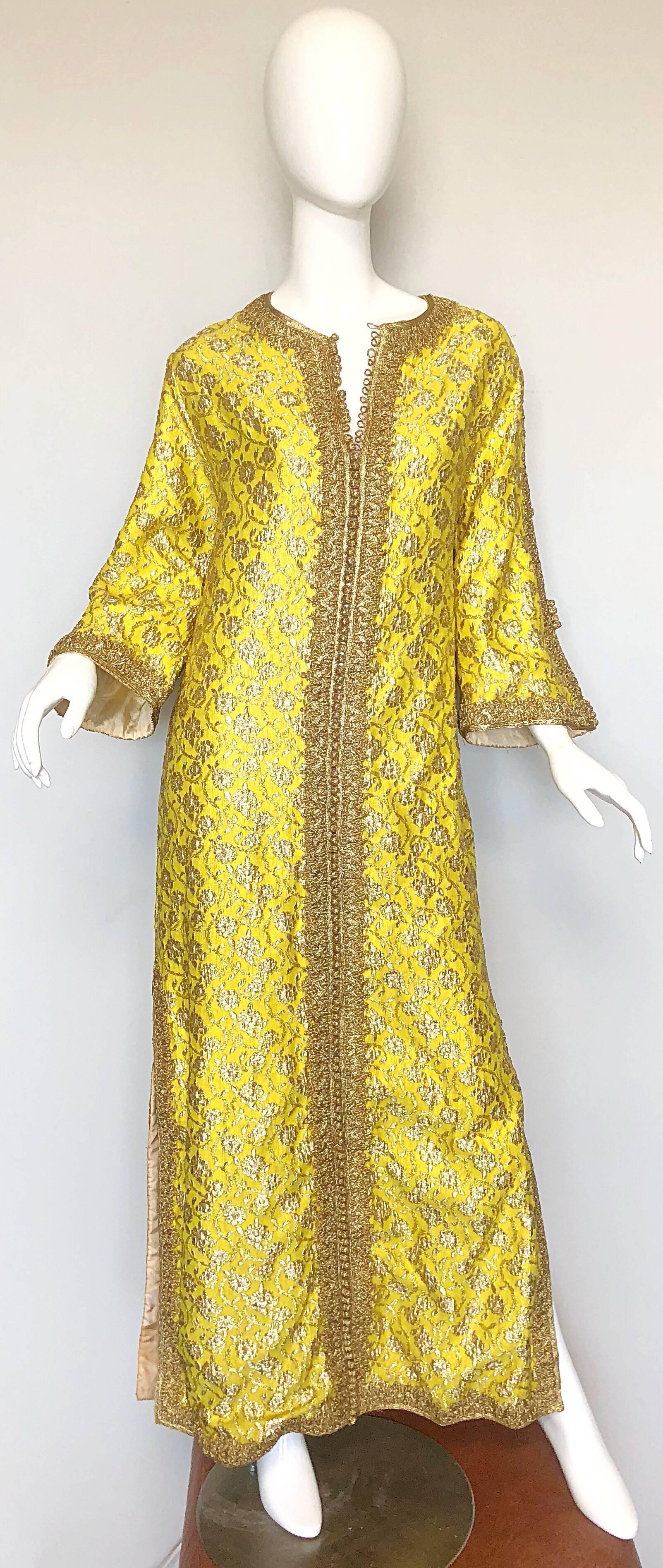 Amazing 1960s Moroccan couture yellow and gold silk brocade kaftan gown! Features a wonderfully hand stitched silk brocade. Gold embroidered trim down the front center features hundreds of gold hand woven functional buttons. Open seams on the outter