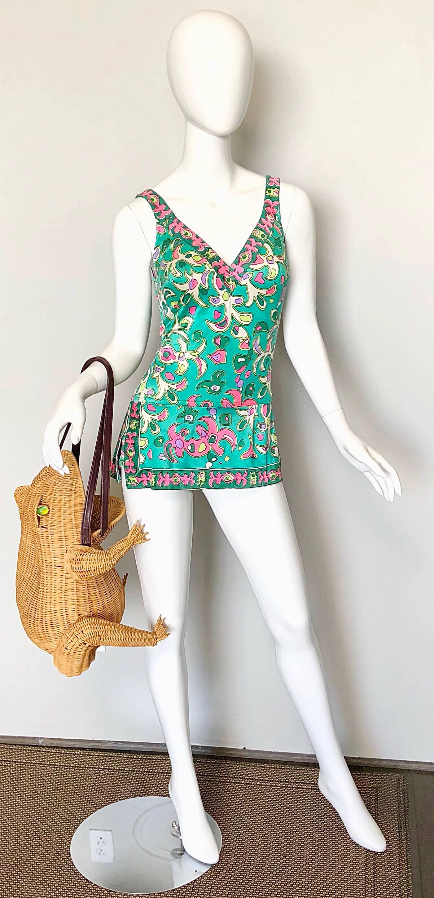 Amazing 1960s sea foam green, pink, kelly green, lime green and white one piece romper swimsuit ! Features a Pucci esque print throughout. Fabric covered buttons on each shoulder strap can adjust strap length. Attached flattering skirt has a slit at