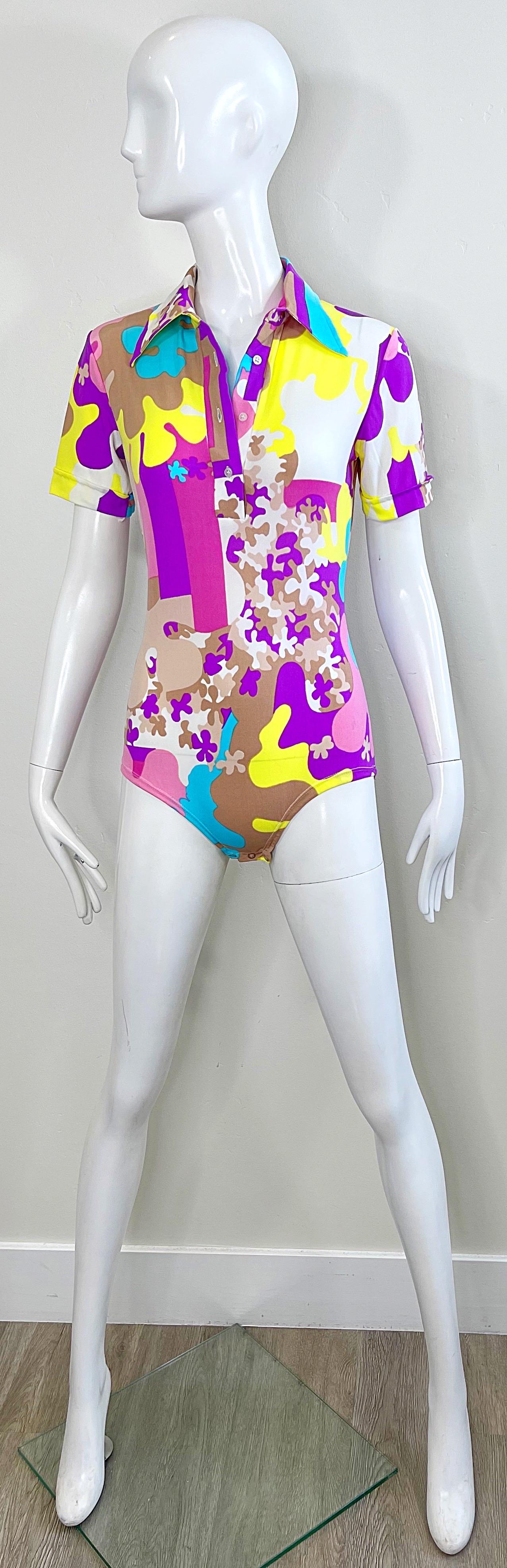 Amazing 1970s brightly colored novelty puzzle print one piece nylon jersey bodysuit ! Features vibrant colors of purple, turquoise blue, pink, fuchsia, yellow, taupe and white throughout. Buttons up the front with snap closures at bottom. 
Pair with