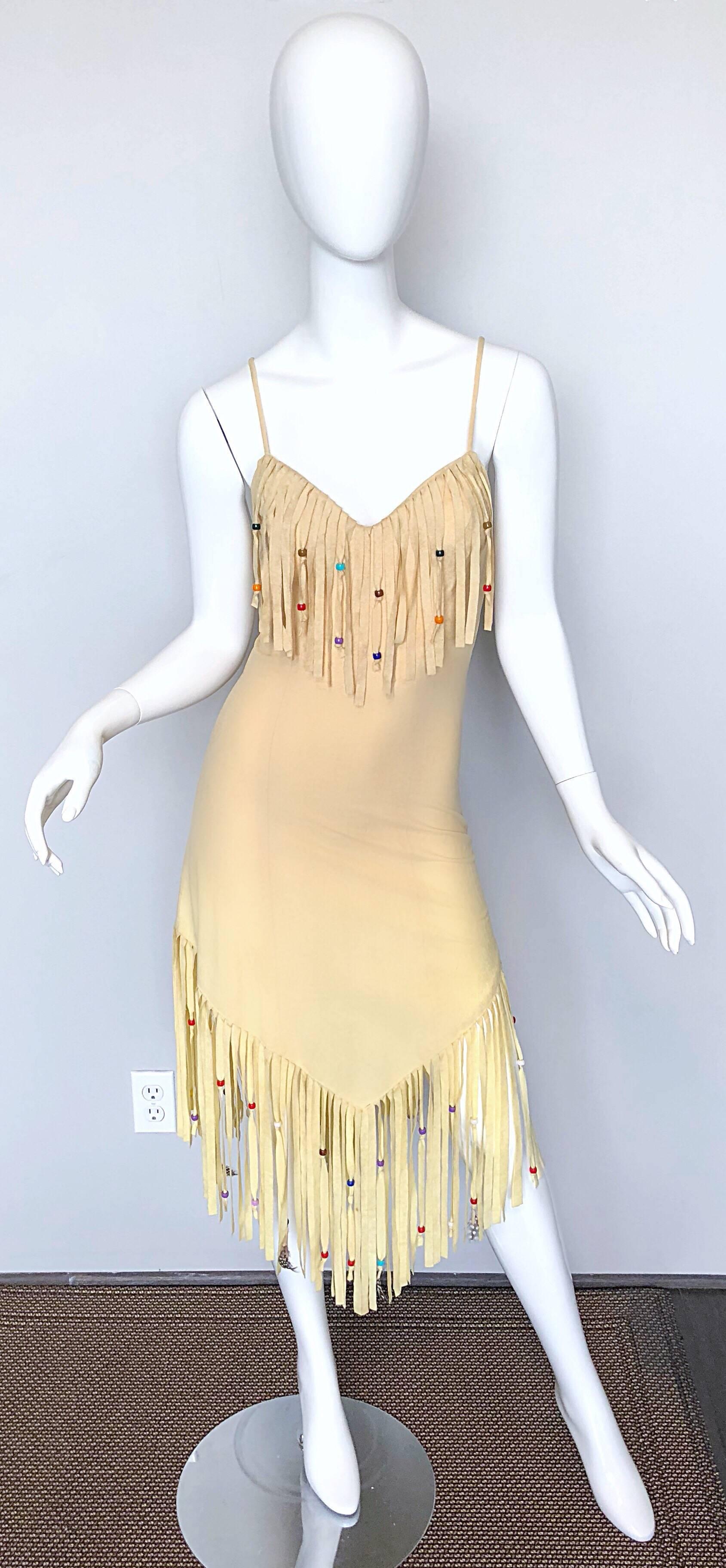Amazing 70s vintage nude / sand colored faux suede sleeveless feathered and beaded fringed dress! Features colorful plastic beads and feathers sporadically throughout the fringes. Soft lightweight faux suede jersey fabric stretches to fit. Hidden