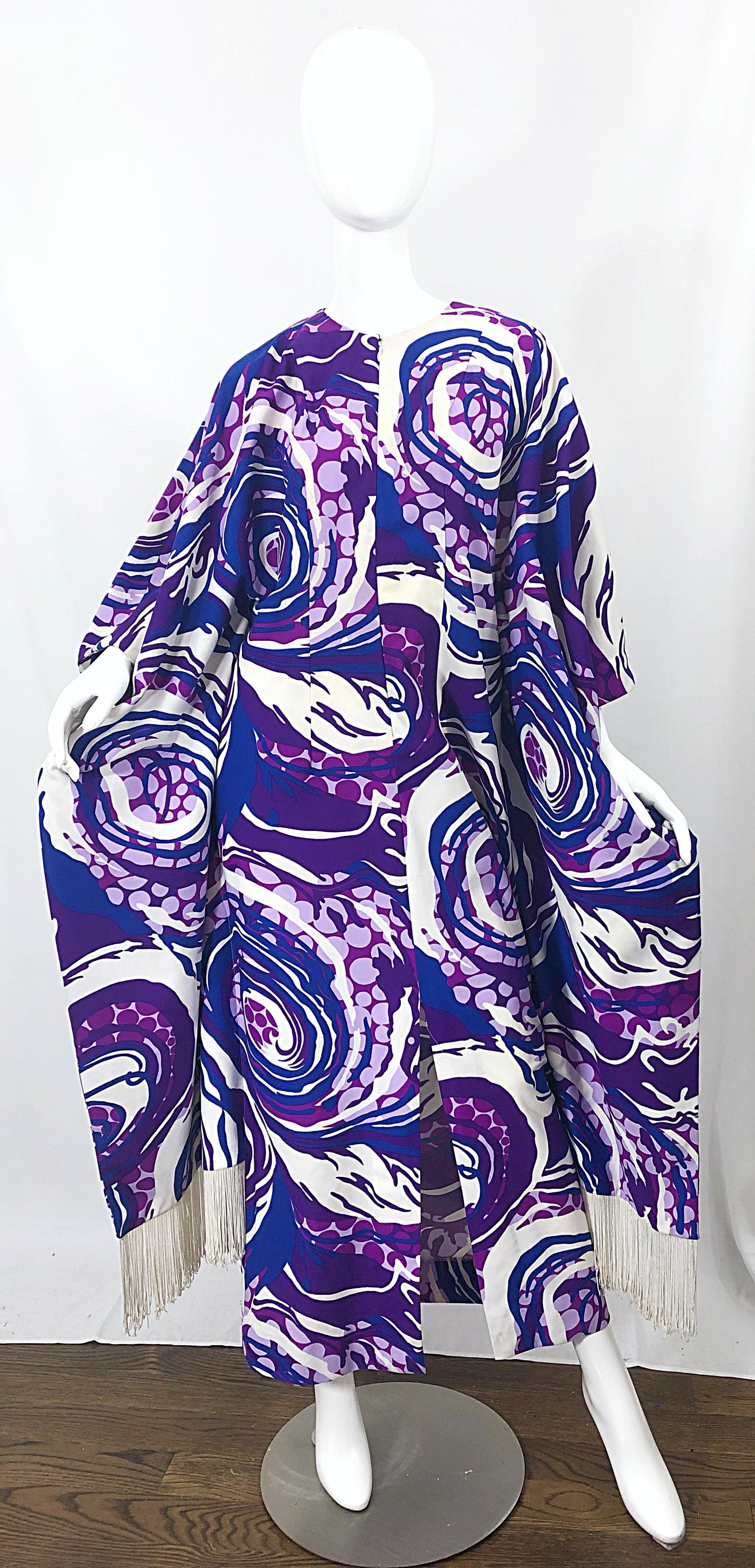 Amazing 1970s purple, blue and white swirl abstract print fringed kaftan / maxi dress! Features white fringe at each side hem. Hidden zipper up the front. In great condition. 
Can fit most sizes due to the natural fit of a caftan