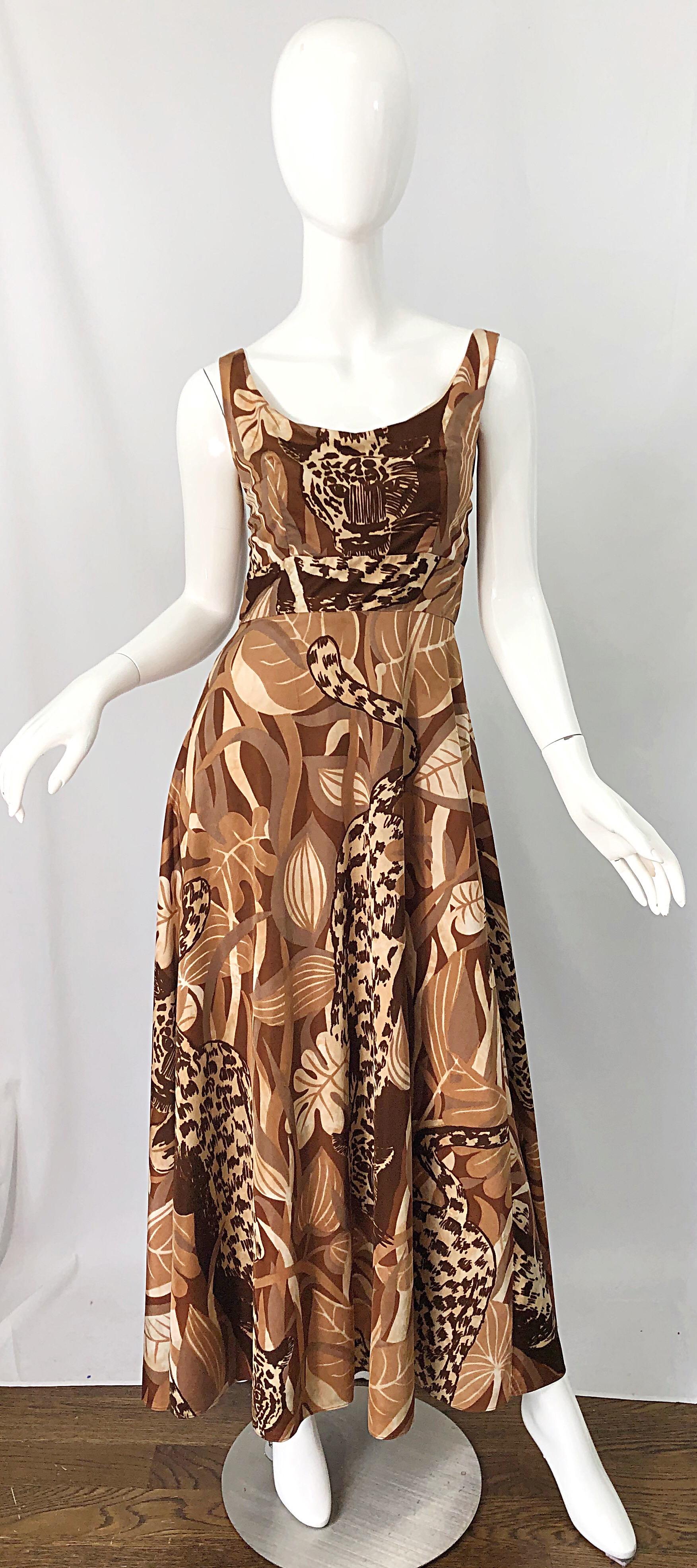 Channel your inner Joe Exotic from Tiger King in this 1970s FUTURA COUTURE leopard print sleeveless leopard print jersey maxi dress! Features leopard prints throughout in brown, ivory, white, terra cotta, and tan throughout. Tailored bodice with a