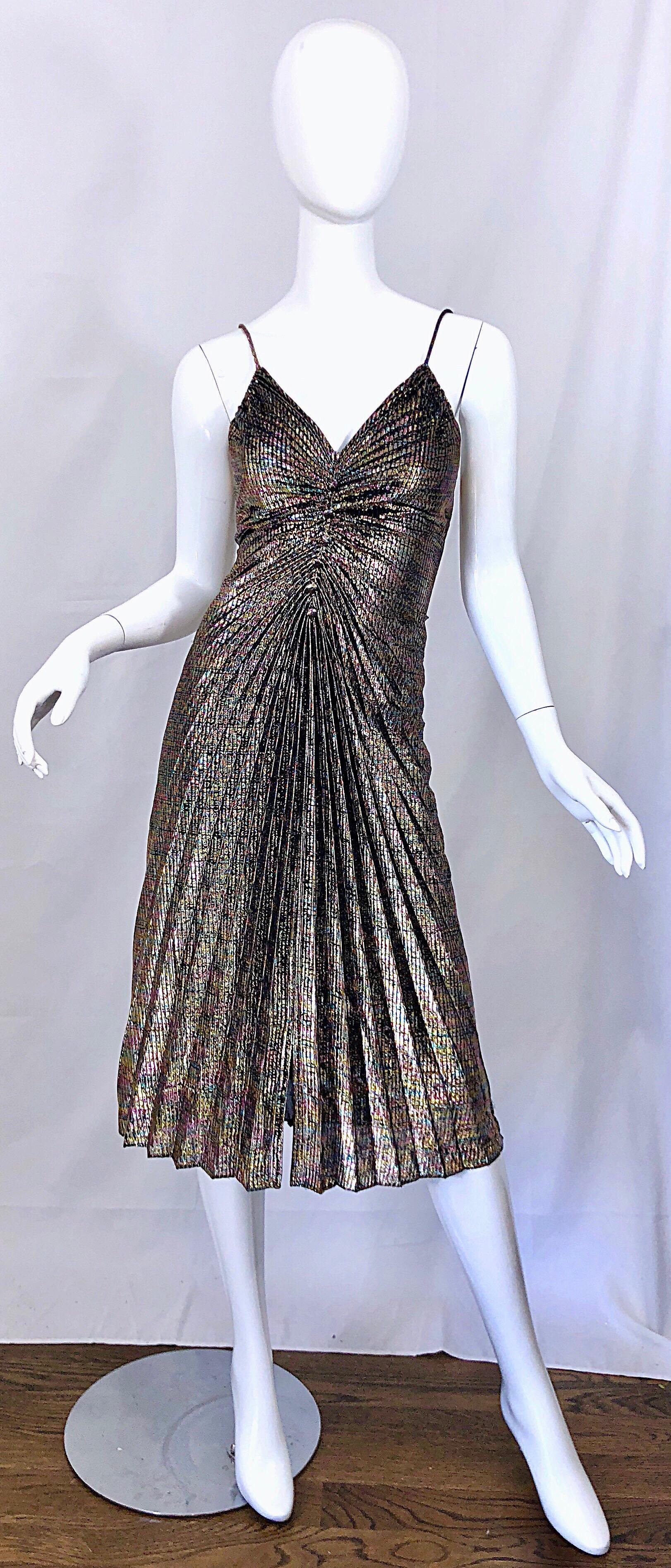 Amazing 1970s disco Studio 54 pleated multi color metallic cocktail dress! Literally features every single color of the rainbow, and will match anything and everything. Looks amazing on, and the ruching hide any 'problem' areas. Hidden zipper up the
