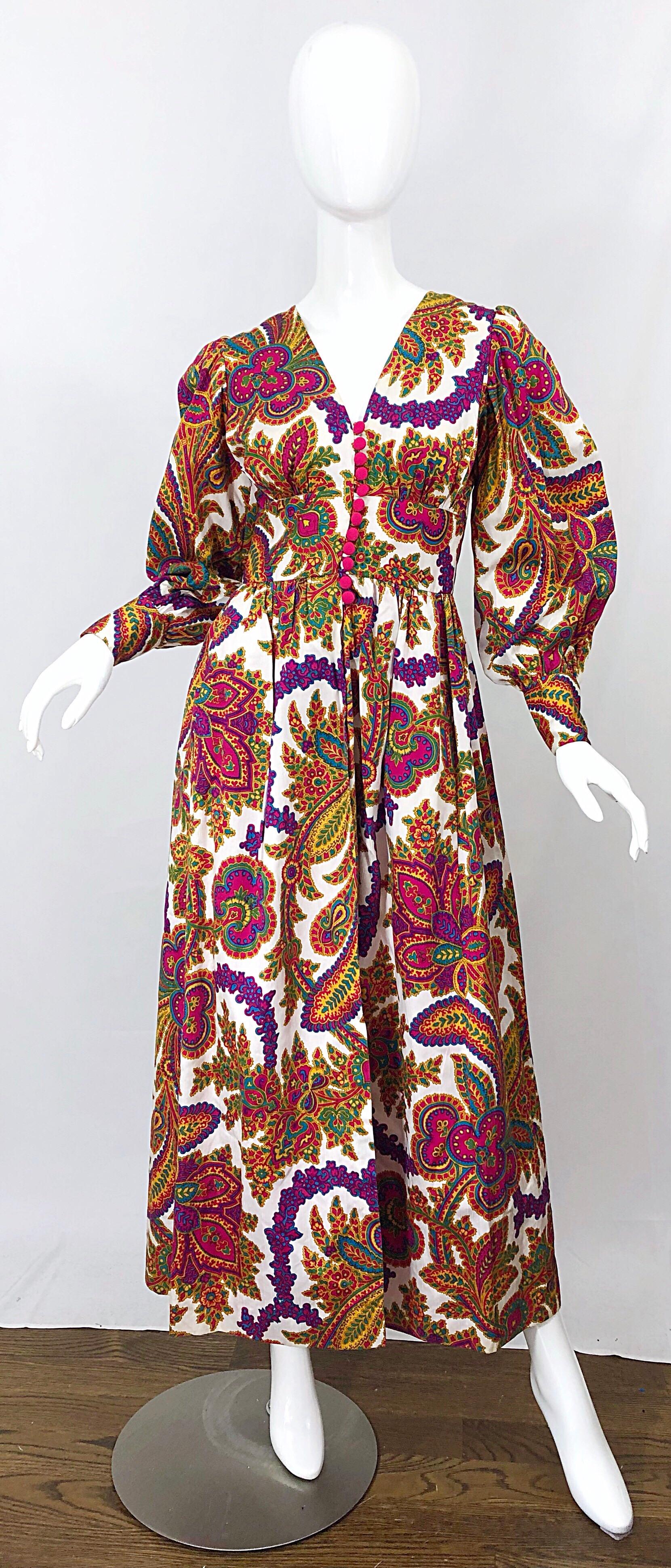 Amazing vintage early 70s regal paisley print boho chic silk gown! Features bright vivid colors in hot pink, fuchsia, purple, green, turqoise blue, orange, and marigold throughout. Bold large paisley prints. Chic bishop sleeves. Silk covered hot