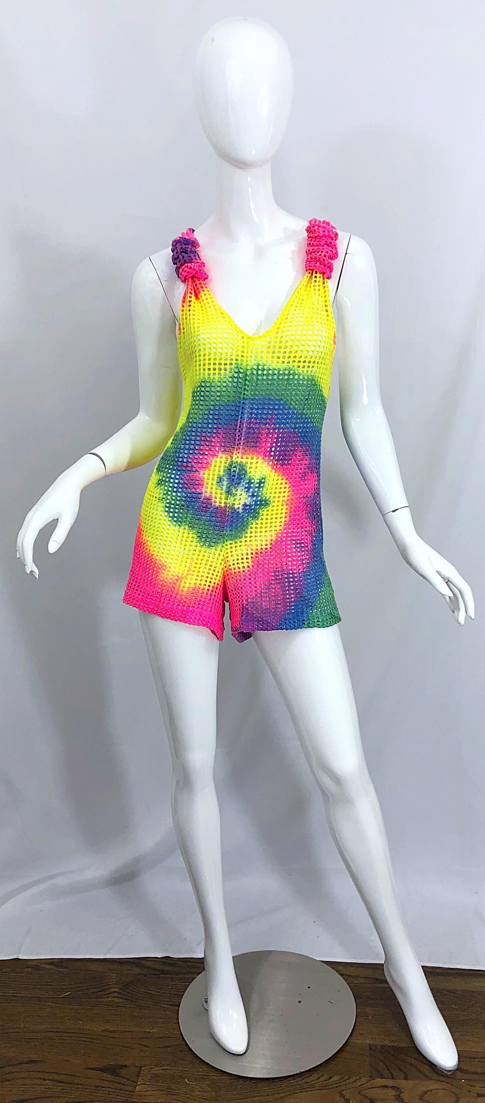 Amazing vintage mid 80s tie dyed bright colorful fishnet cut-out romper! Features bright colors in vibrant hues of hot pink, blue, purple, green, and neon highlighter yellow throughout. Flattering racerback style. Simply step into this and go. In