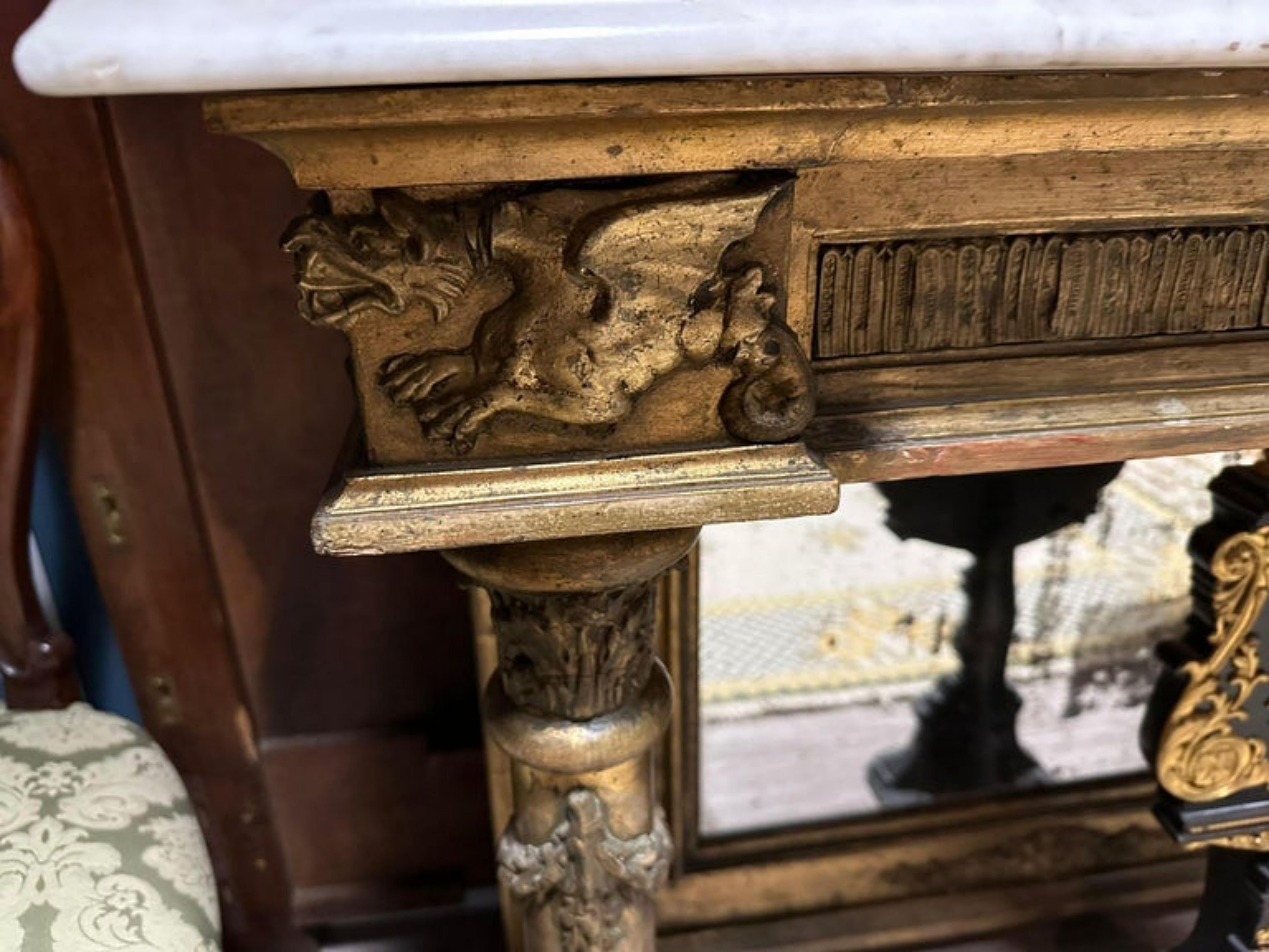 Amazing 19th CENTURY Important Console Empire Napoleon III
In gilded wood carved with dragons and a mascaron head, resting on two columns at the front and a large vertical spacer holding a mirror at the back. 
Topped with a white Carrara marble