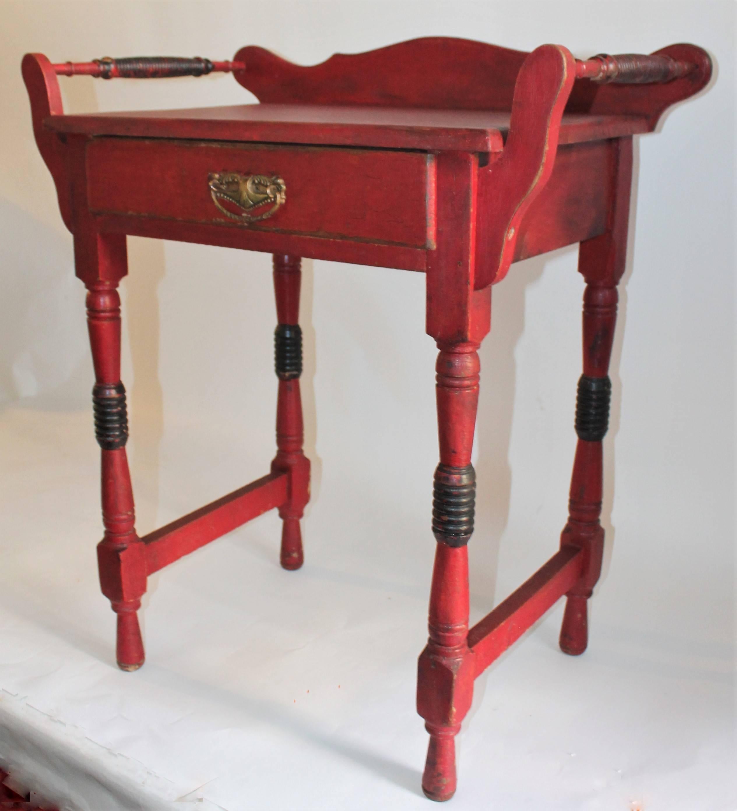 This fantastic 19th century original crackle red with black trim nightstand or side table is in great condition and is very sturdy. The end rods were made for hanging show towels in a bathroom or bed room with the old wash bowl and pitcher set .This