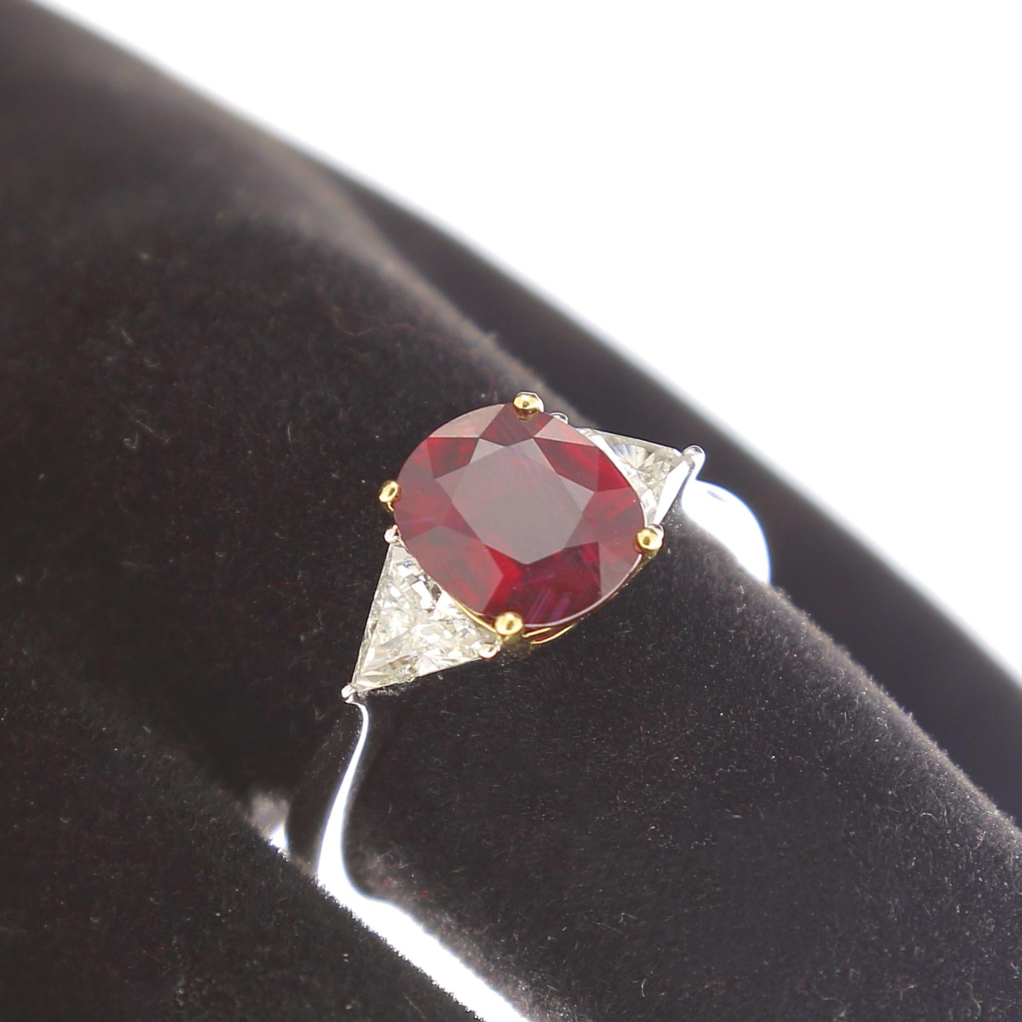 An amazing cushion ruby ring, set with 2 Trillion cut diamonds (also called “trilliant” or “trillian”).
The total weigh of the ruby is 2.08 Carats, the ruby is accompagned with a certificat stating as a Mozambique Ruby, and no indications of