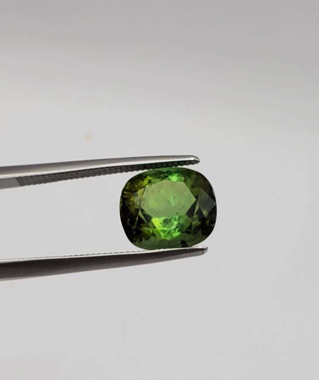 Presenting a captivating apple green tourmaline of exceptional quality. This gemstone weighs 4.21 carats, boasting substantial size and allure. The dimensions measure 10.42 mm in length, 9.17 mm in width, and 6.52 mm in height, creating a