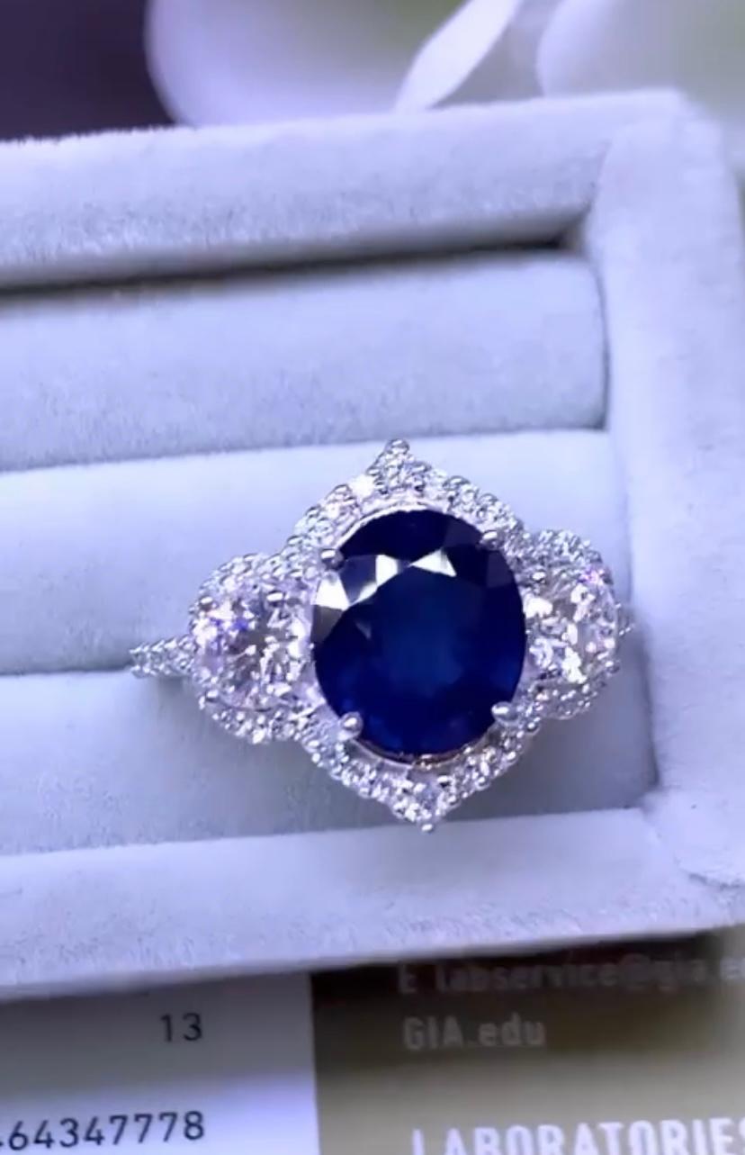 An exquisite design, so glamour and chic style, a very adorable piece. 
Ring come in 18k gold with a natural Blue Ceylon Sapphire, in perfect oval cut , extra fine  quality, of 3,70 carats, and two side GIA certified natural diamonds in round