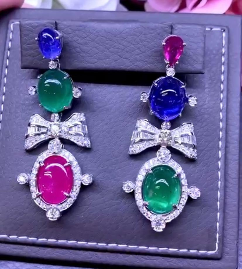 An exquisite design , so stunning and colourful , a very glamour style. 
Earrings come in 18k gold  with 2 pieces of natural Zambia emeralds, in cabochon cut , 20,41 carats, fine grade, 2 pieces of natural tanzanites 17,28 carats, fine quality, and
