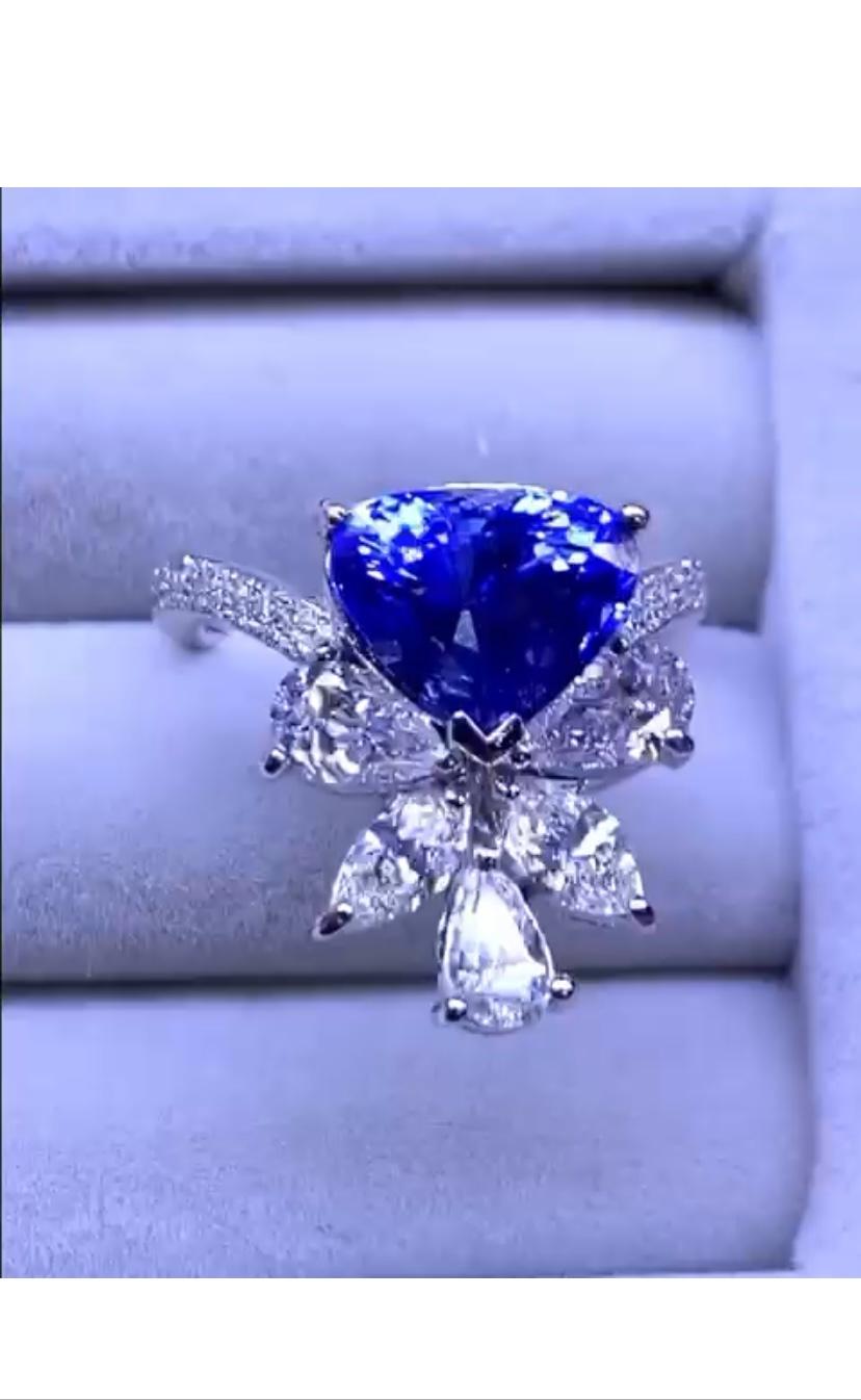 Magnificent design in 18k gold with a heart cut Ceylon sapphire of 4,19 carats, extra fine grade and quality, amazing color, and special cut diamonds of 1,73 carats,D-F/VS .
Very adorable style . 
Handcrafted by artisan goldsmith.
Excellent