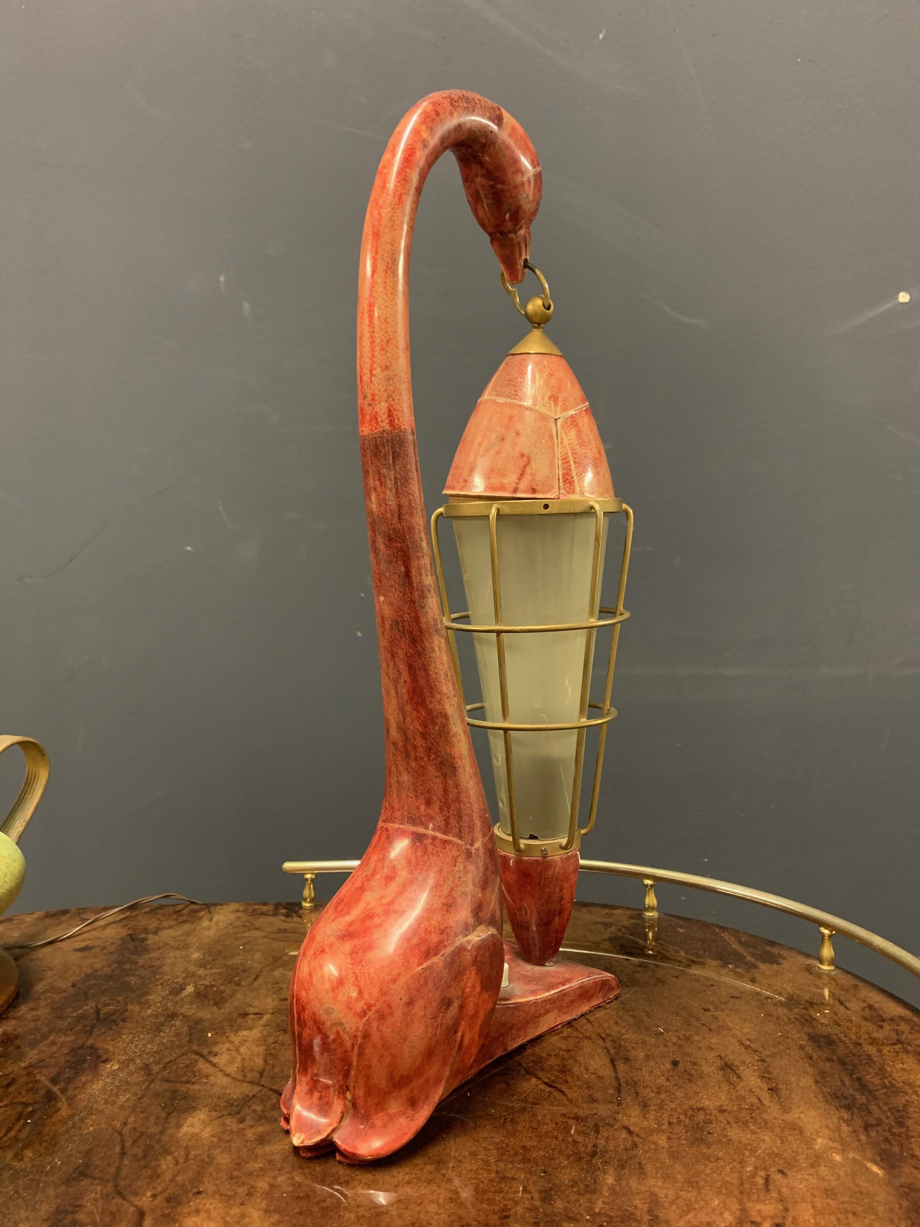 A very graceful and modern table lamp made by Aldo Tura. The body of the swan is done in goatskin. Brass accents. Wonderful color and nice condition.
