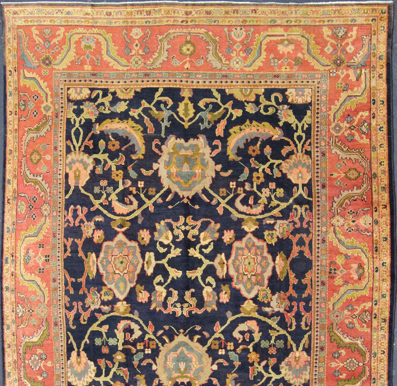 Amazing antique Persian Sultanabad carpet in navy blue background, yellow, citron green and rose red with large scale flowers. Keivan Woven Arts / 13-0511 / country of origin / type: Iran / Sultanabad, circa 1880.  19th century Sultanabad. Navy