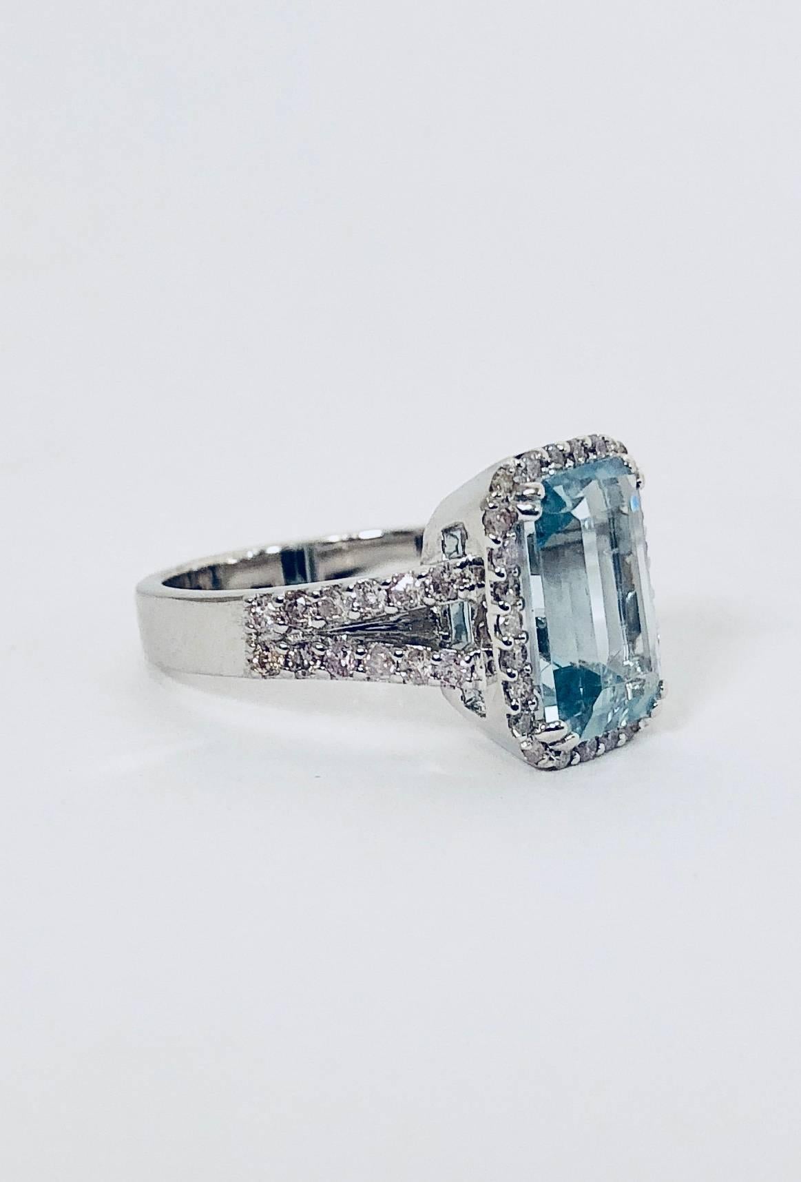 Perhaps one of the softest, most ladylike combinations in all of fine jewelry.  Beautifully crafted in 18 karat white gold this ring features  an emerald cut aquamarine weighing 2.43 carats, embraced by a white round diamond micro pave halo that