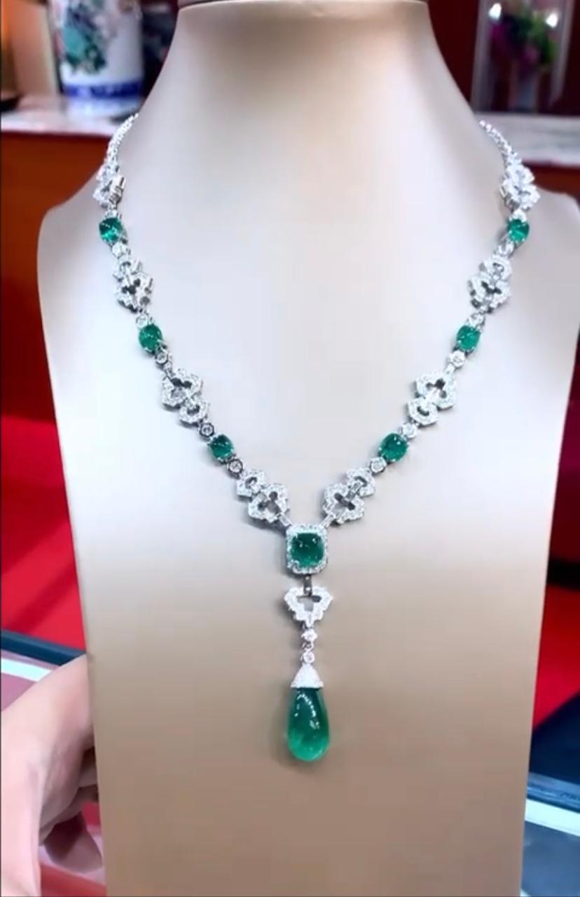 An exquisite Art Deco design , handmade necklace in 18k gold, so glamour and chic design, with a drop cut Zambia emerald of 18.14 carats, and 7 pieces of Zambia emeralds, fine quality, of 15.77 carats, and diamonds in round brilliant cut of 5.83