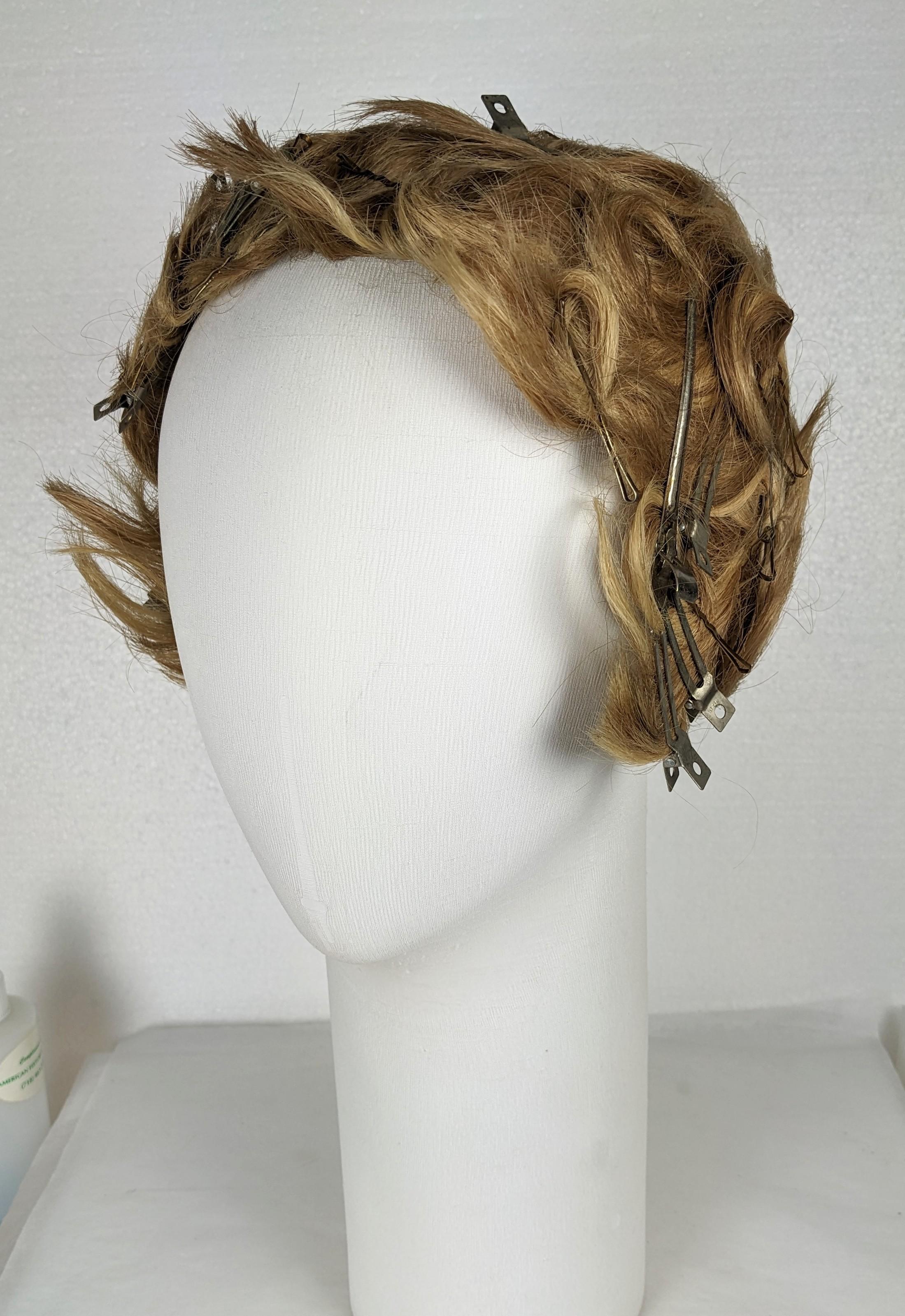 Amazing Charming Flapper wig from the 1920's. Soft waves and tight curls held by a myriad of bobby pins and clips a la Galliano, all sewn onto a net cap base labeled 