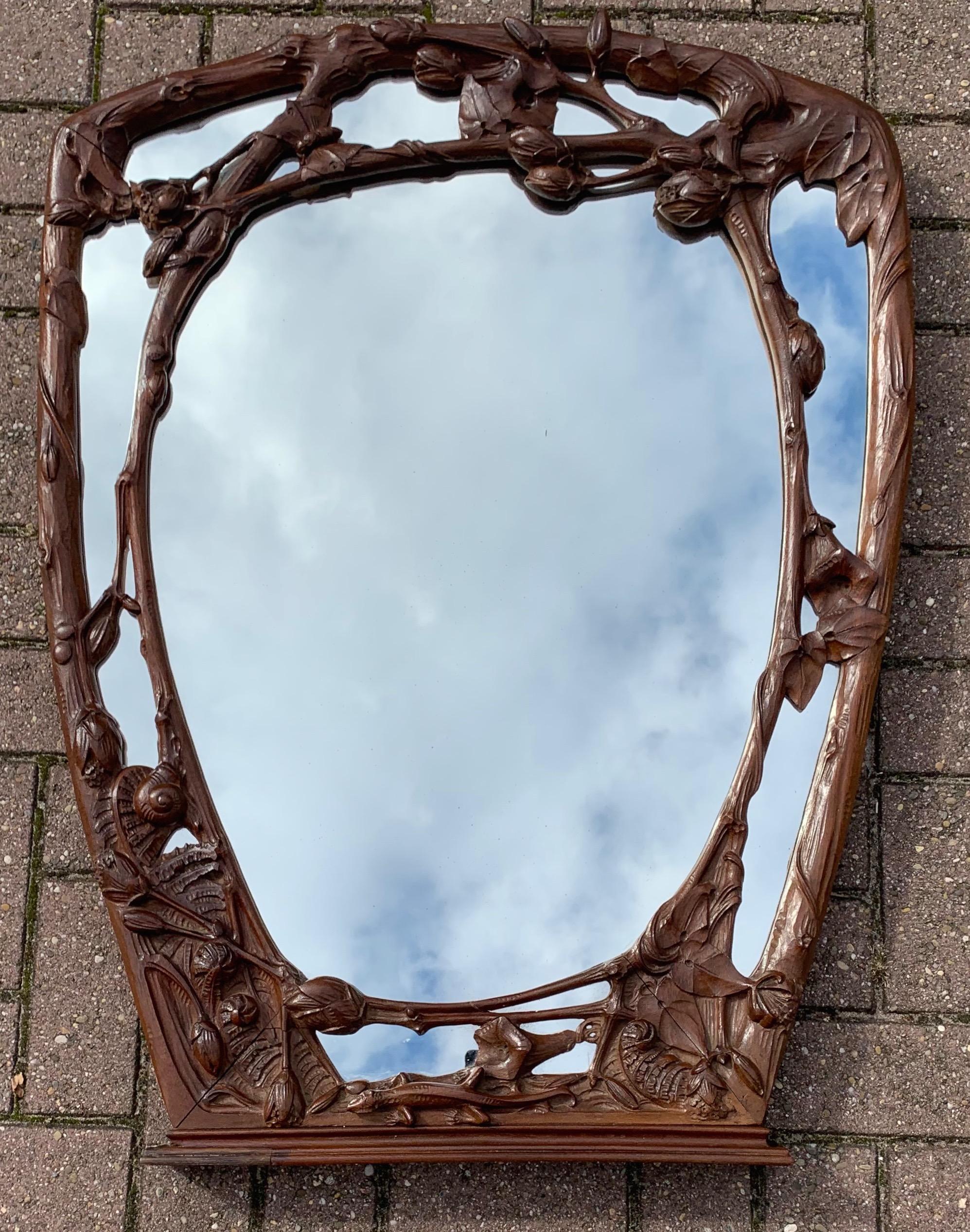 Perfect size and wonderfully artistic antique wall mirror.

If you are looking for unique Arts & Crafts antiques that make you want to stop and study them then this hand carved work of beauty could soon grace your living space. Designed and all