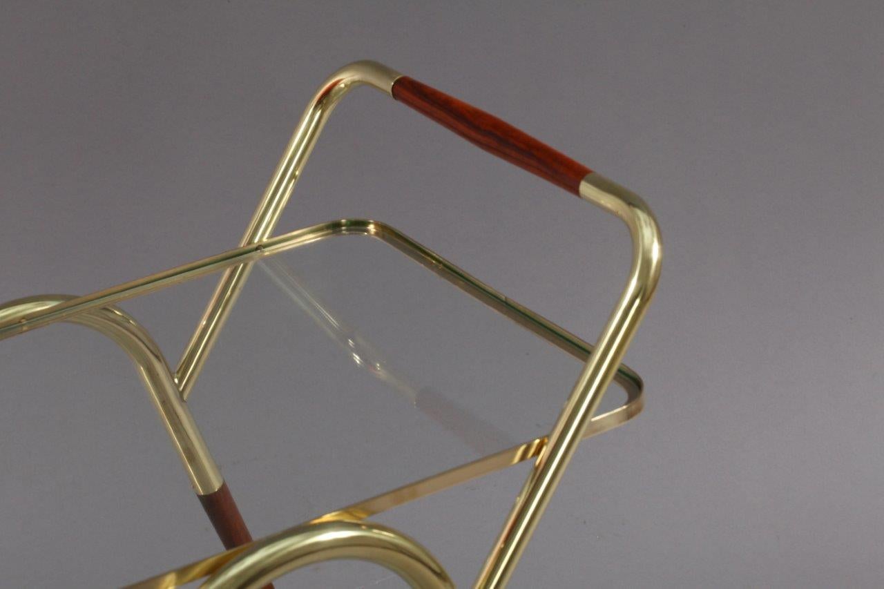 Bar cart,
Designed Cesare Lacca,
Italy, 1950.
Brass, teakwood,
rollable, three bottleholder.
Measure: Width 30 inch (75cm).
Depth 17 inch(43cm).
Height 28 inch (71cm).