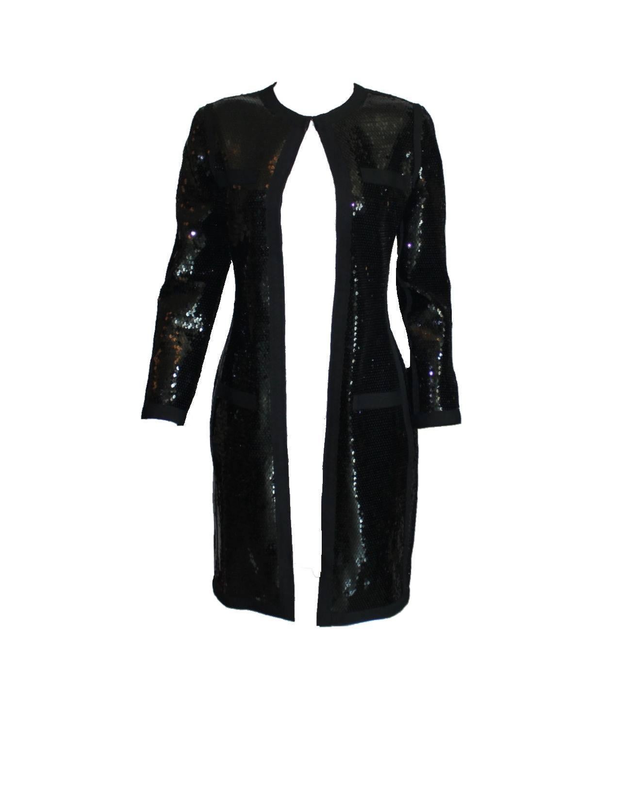 A stunning piece by Chanel
Designed by Karl Lagerfeld
A very versatile piece - can be worn as dress, coat or jacket
Shiny black sequins
Closes in front with a zip with CC logo
Fully lined with black silk
Perfect condition
Made in France
Dry Clean