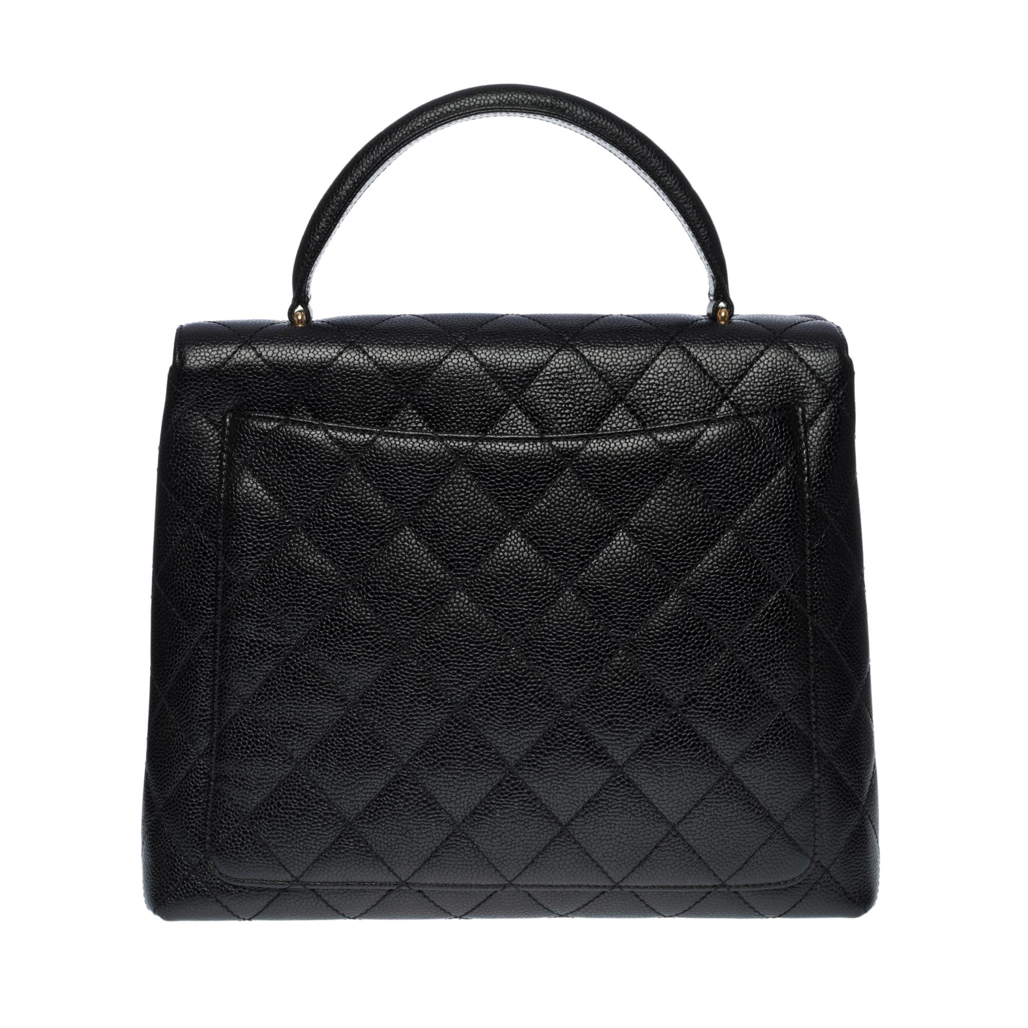Lovely Chanel Coco Handle handbag (also called Kelly) in black quilted caviar leather, gold-plated metal hardware (24k), black leather handle for a handheld

Flap closure, gold plated CC clasp
A patch pocket on the back of the bag
Black leather