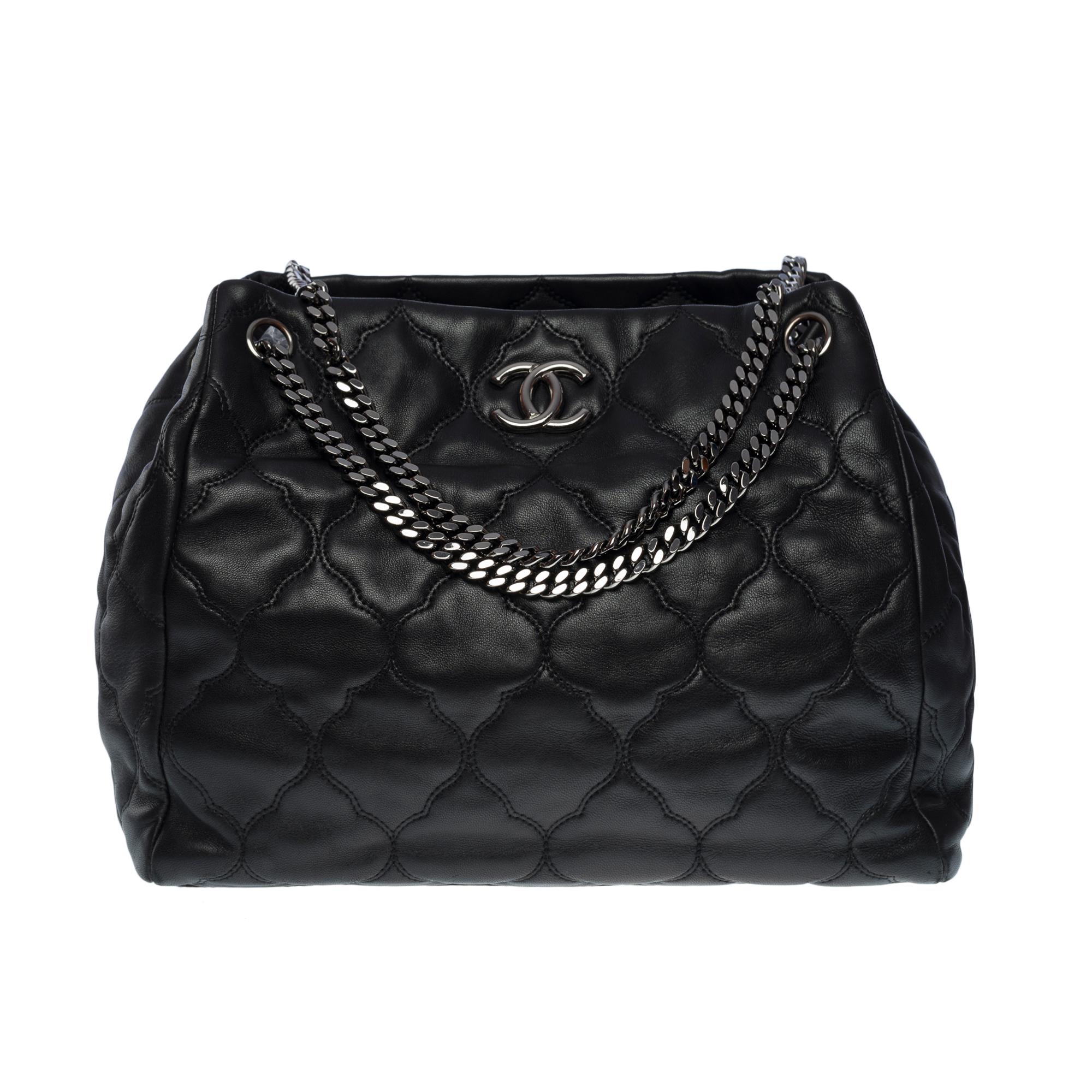 Chanel Hamptons shoulder bag in black puffy quilted leather, silver metal hardware, flat silver metal chain handle for hand or shoulder support

Silver metal signature closure on front
Black leather lining, one zippered pocket, one patch