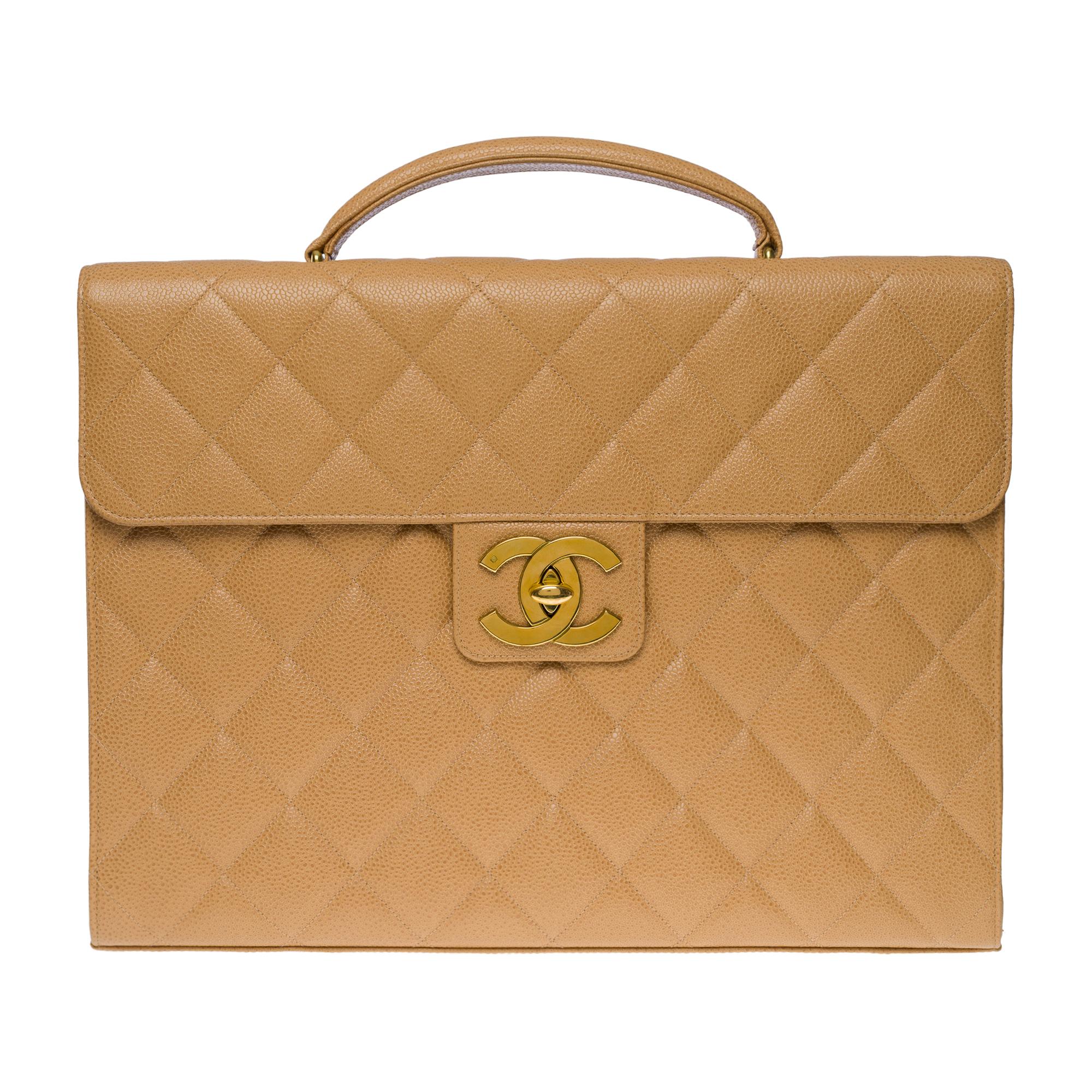 Classy Chanel Briefcase in beige caviar quilted leather, gold-plated metal hardware, a simple handle in beige caviar leather for a hand carry
Patch pocket on back of bag
Closure by flap, clasp with CC gold logo latch
Black leather lining, one fabric