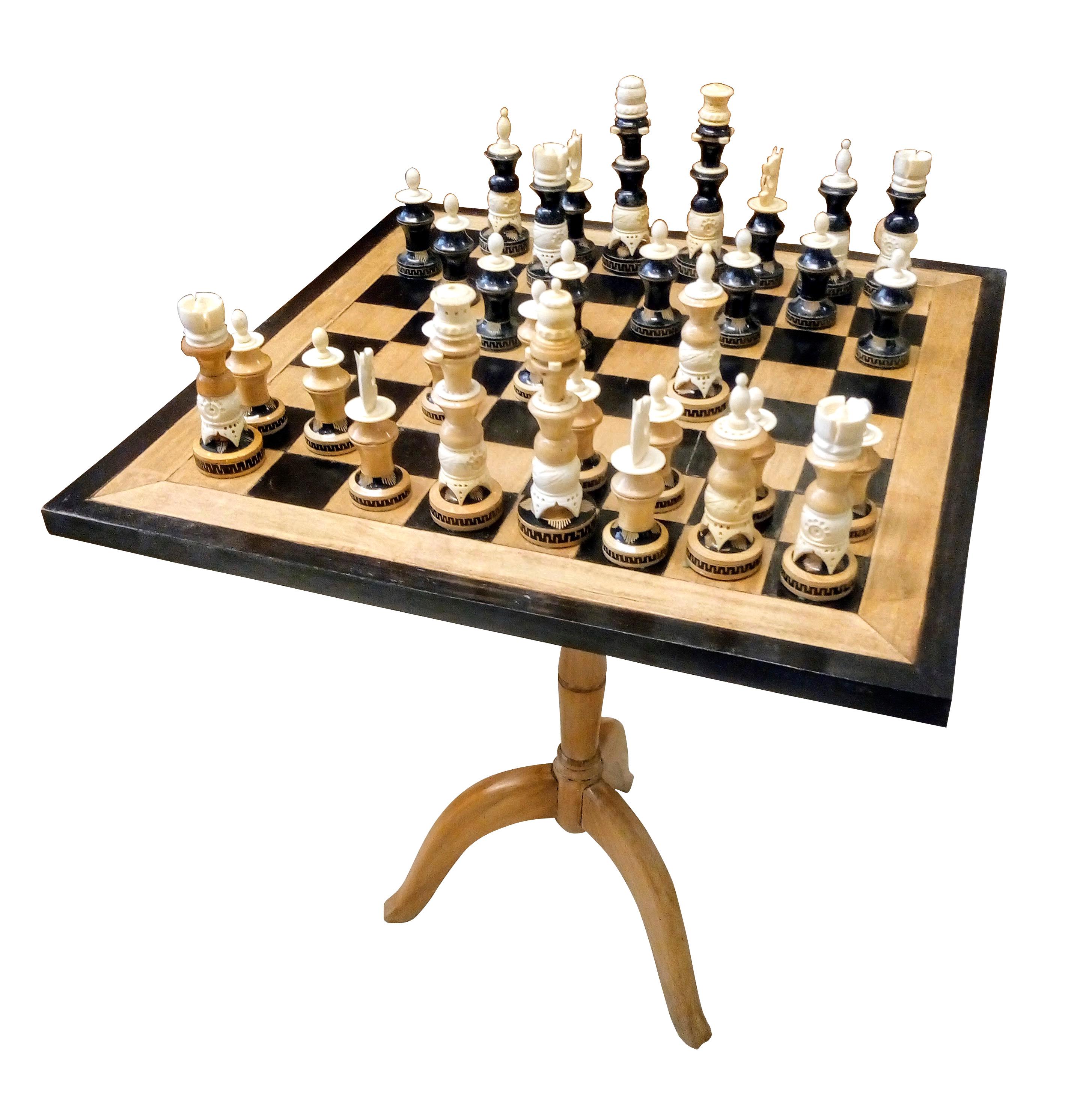 Highly artistic set of chess pieces handcrafted in wood and bone with standing wood table and board.
This set was manufactured in Michoacán State, Mexico circa 1970, 16 pieces have the natural original light wood finish, while the rest 16 are dyed