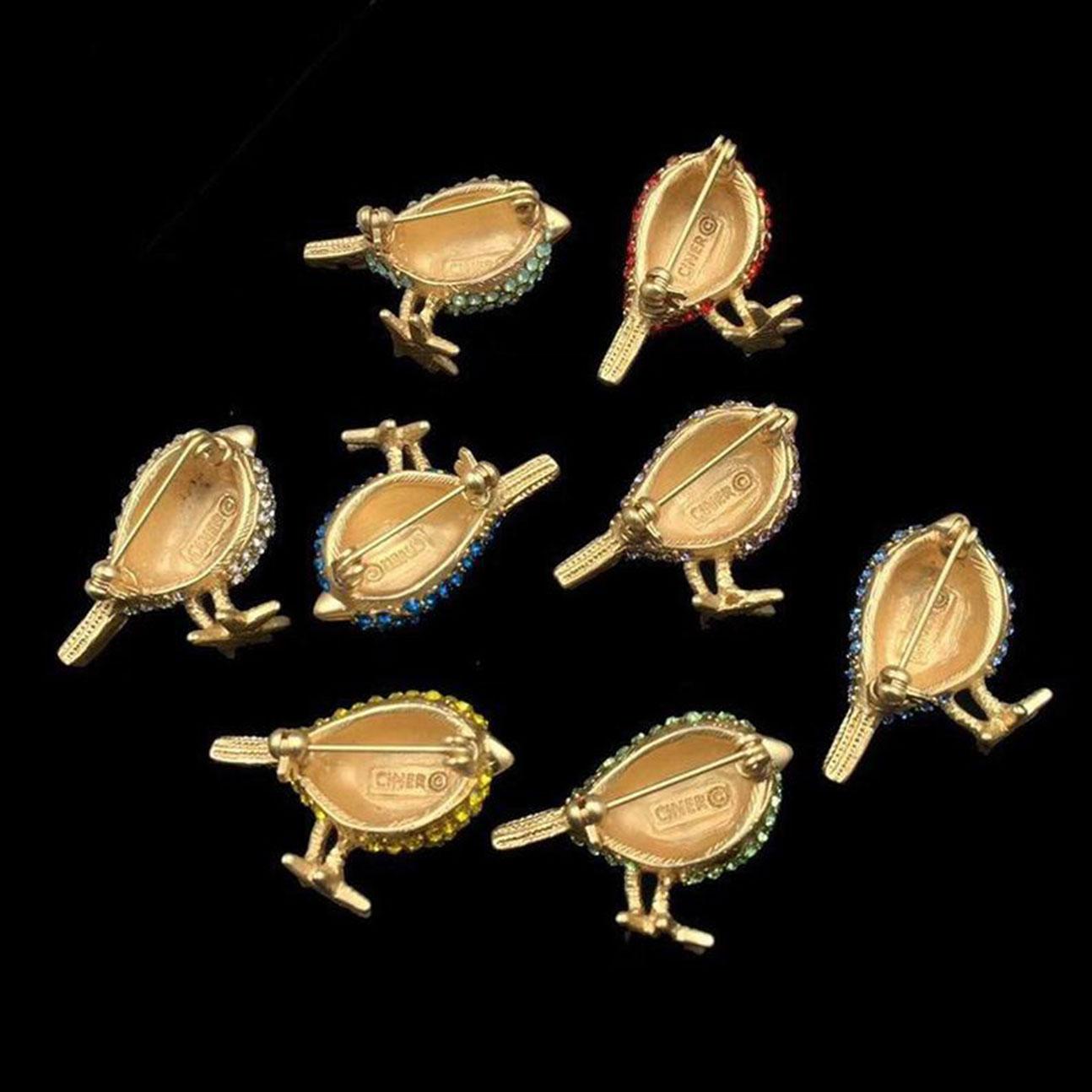 A Charming collection of eight CINER Chickadee Bird Pins, crafted in yellow Gold plate and set with assorted Faux colored Gem Stones in different colors; Each Birdie is Signed CINER;  measuring approx. 1.50